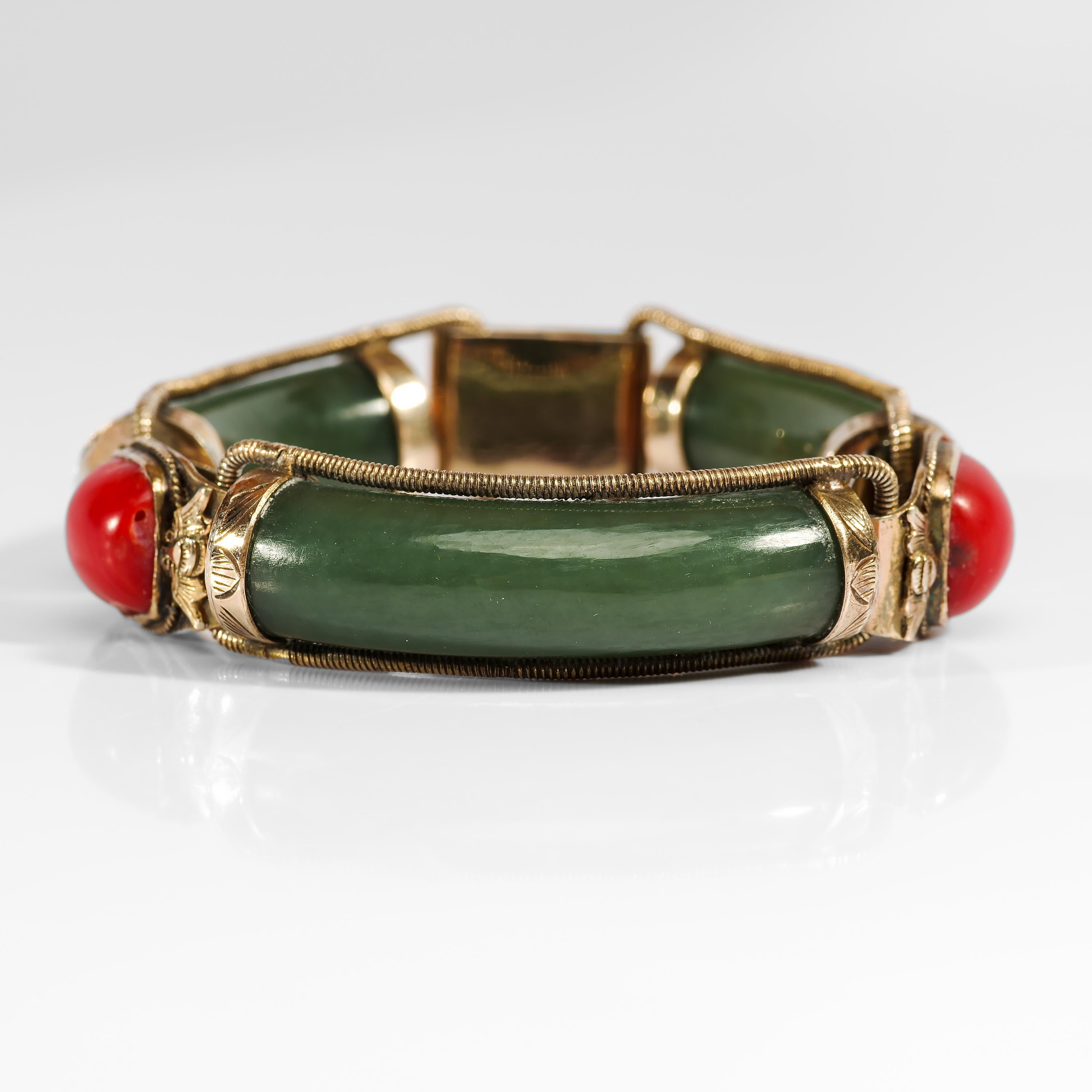 Thick bars of cool green Nephrite jade, succulent and translucent, their original antique polish a thing to behold. Each link is secured by gilt-silver caps, encircled with thick textured wire, and joined by bezel-set natural precious coral