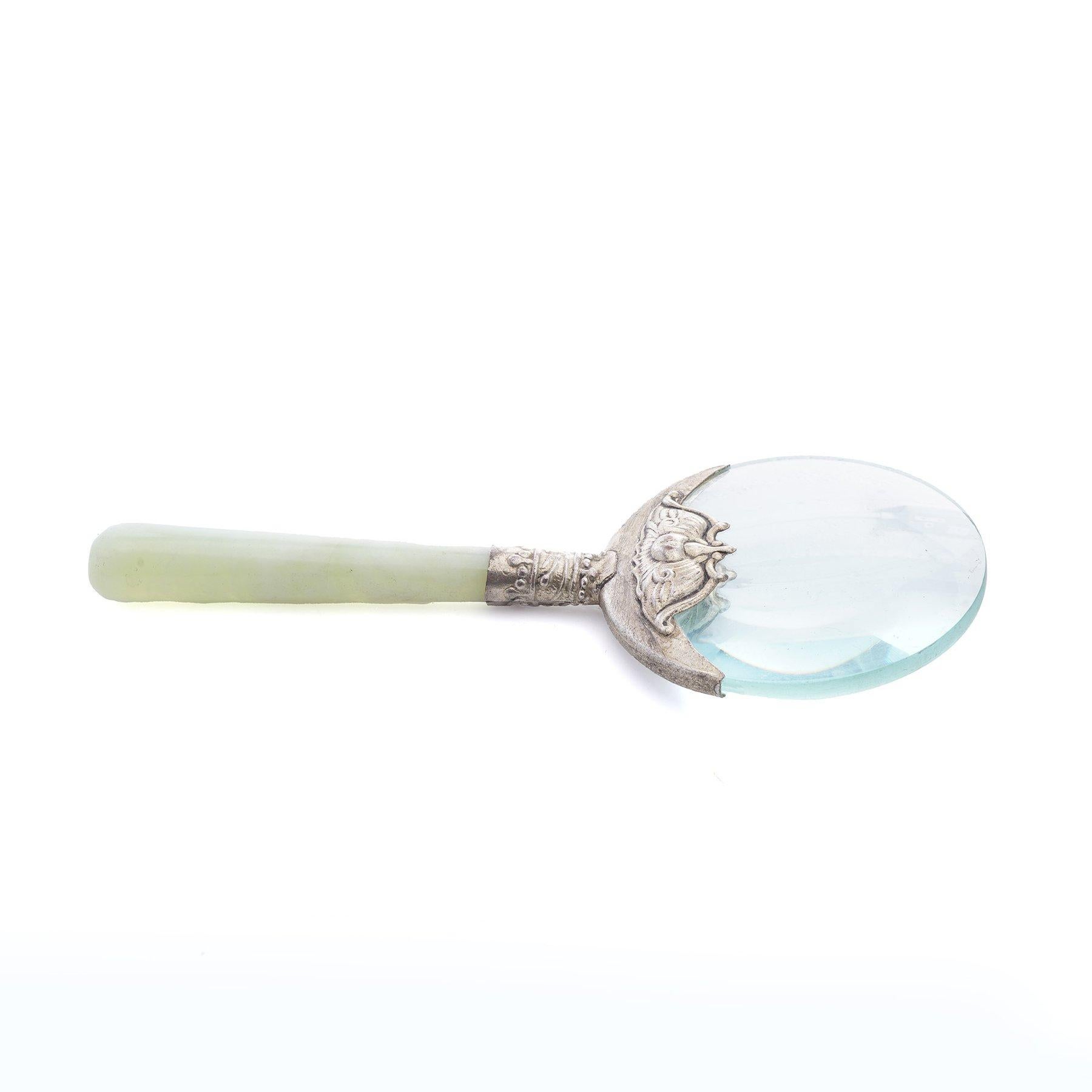 Antique Jade-Handled Magnifying Glass with Ornate Silver plated Detailing.

Dimensions:
Height:14 cm
Width: 6 cm
Weight: 65 grams

Key Features:
Design:

The handle is crafted from polished jade, exuding a smooth, cool texture and a soft green