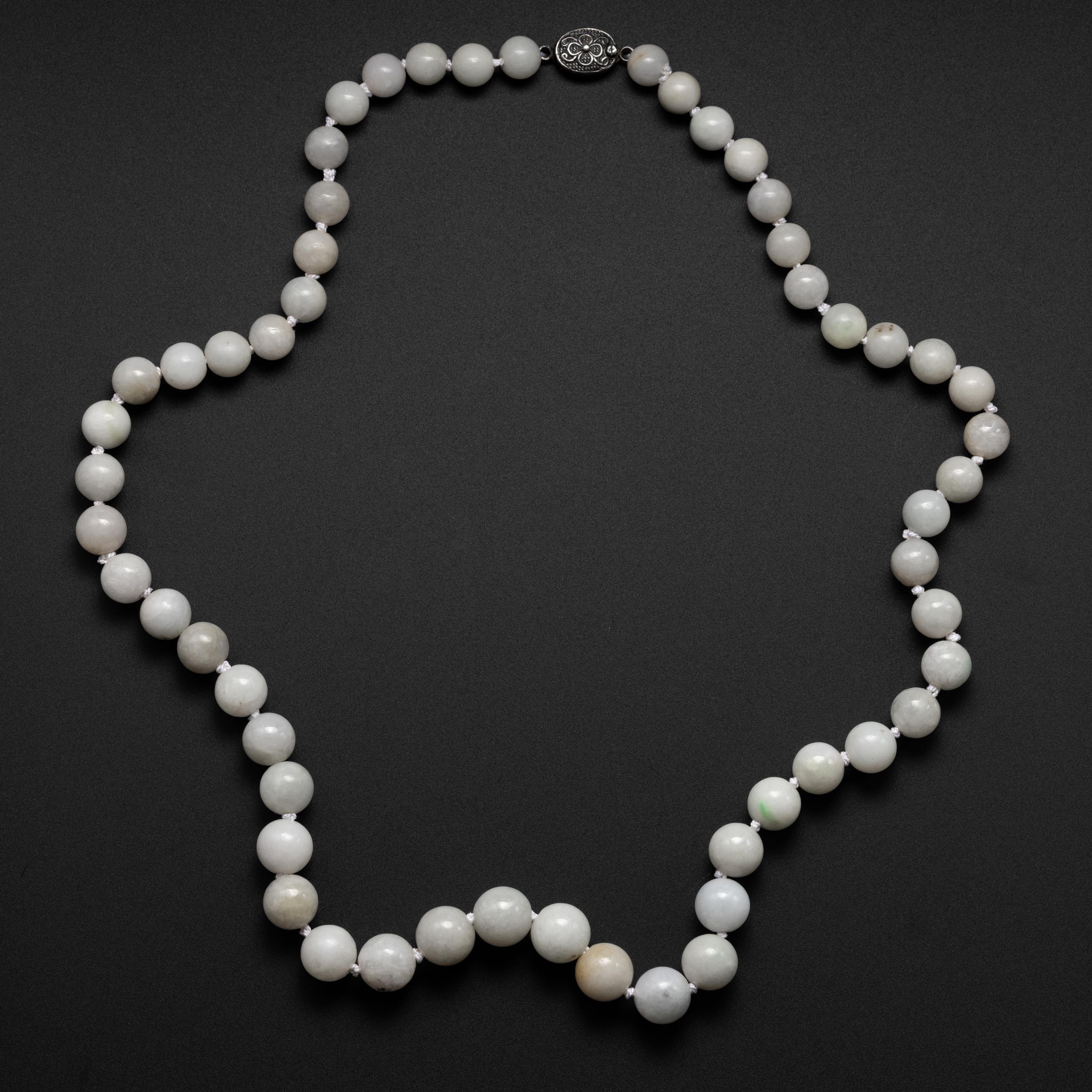 This elegant, natural antique jade necklace is exactly what you would have seen in the window of a small Shanhai jade shop in the 1920s. This necklace was created entirely by hand for the booming tourist market that defined Chinese cities like