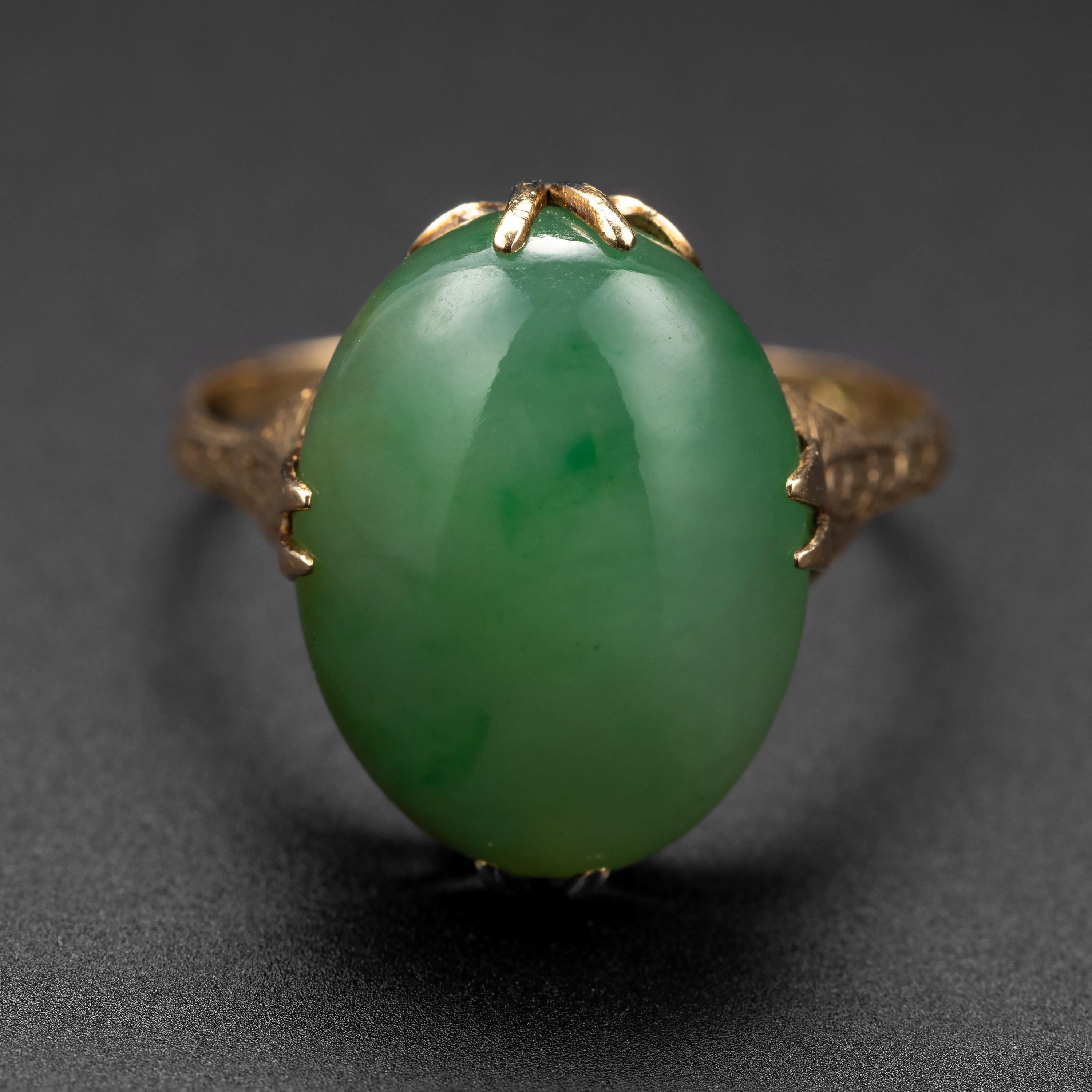 Perfectly proportioned, this antique Edwardian-era jade ring is a showcase for a highly translucent, luminous orb of certified natural and untreated jadeite jade from Burma. Created by hand near 1900, this elegant and classic jade ring features a