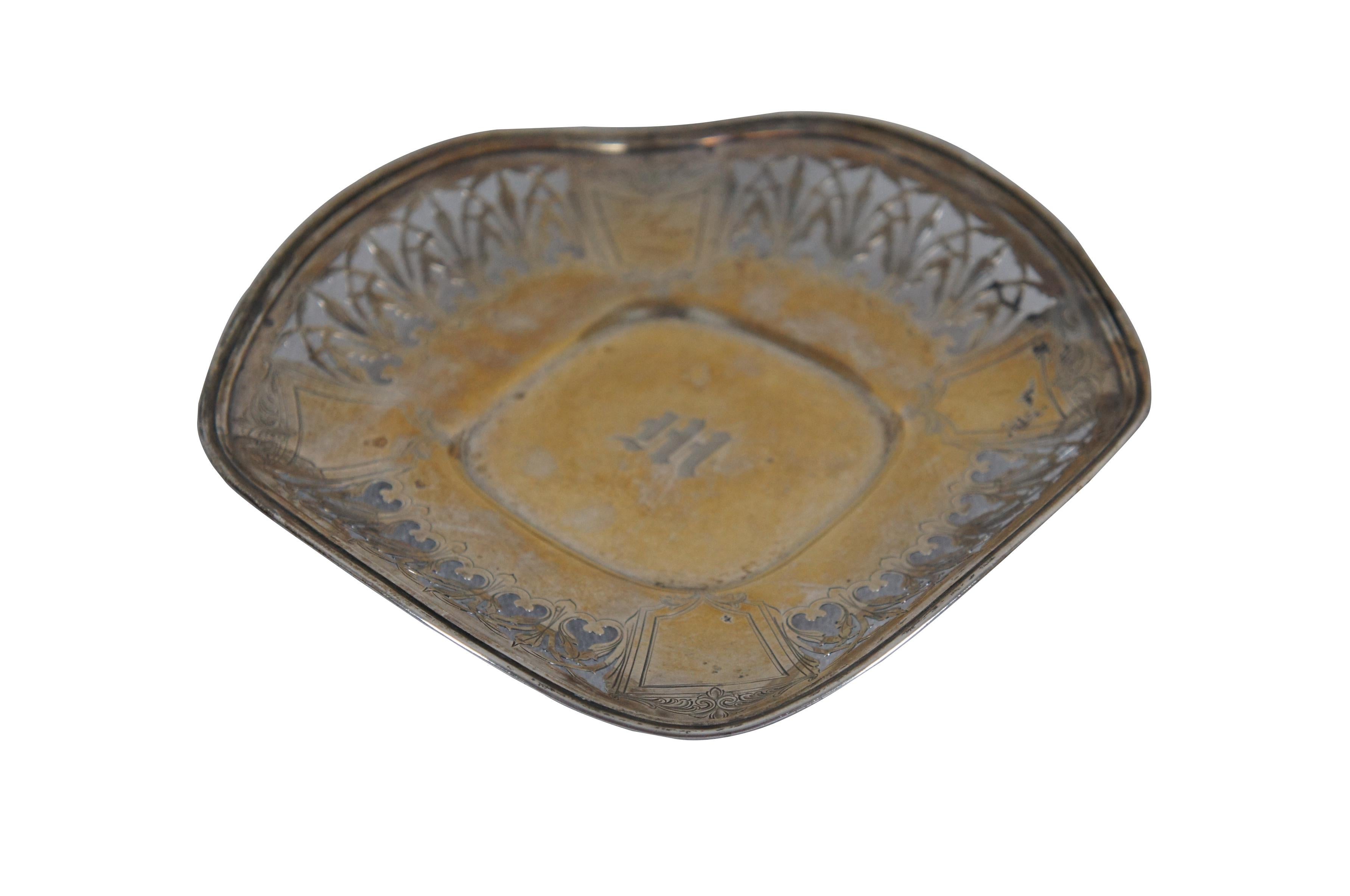 Late 19th to early 20th century sterling silver serving tray / dish, item number 1713, by James E. Blake & Company. Square serpentine shape with rounded corners and sides ruffled upward. Pierced leaf motif with etched foliate shields at the corners
