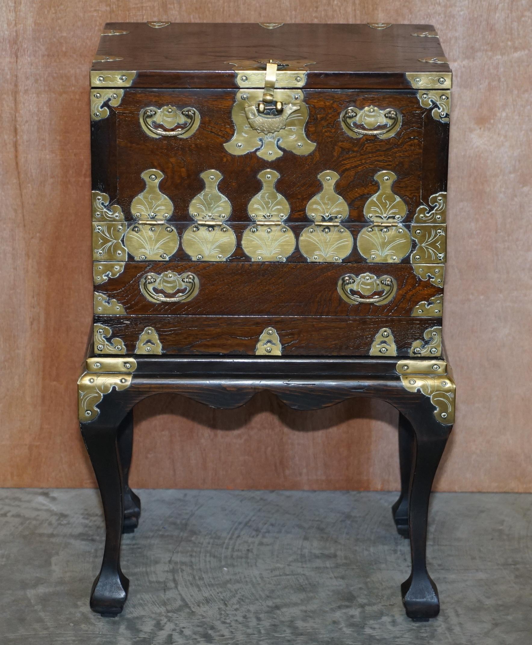 We are delighted to offer for sale this lovely original antique Japanese Elm & polished brass chest on stand

A very good looking well made and decorative piece. The chest is an ideal lamp or wine table size, it has a large top cupboard section,