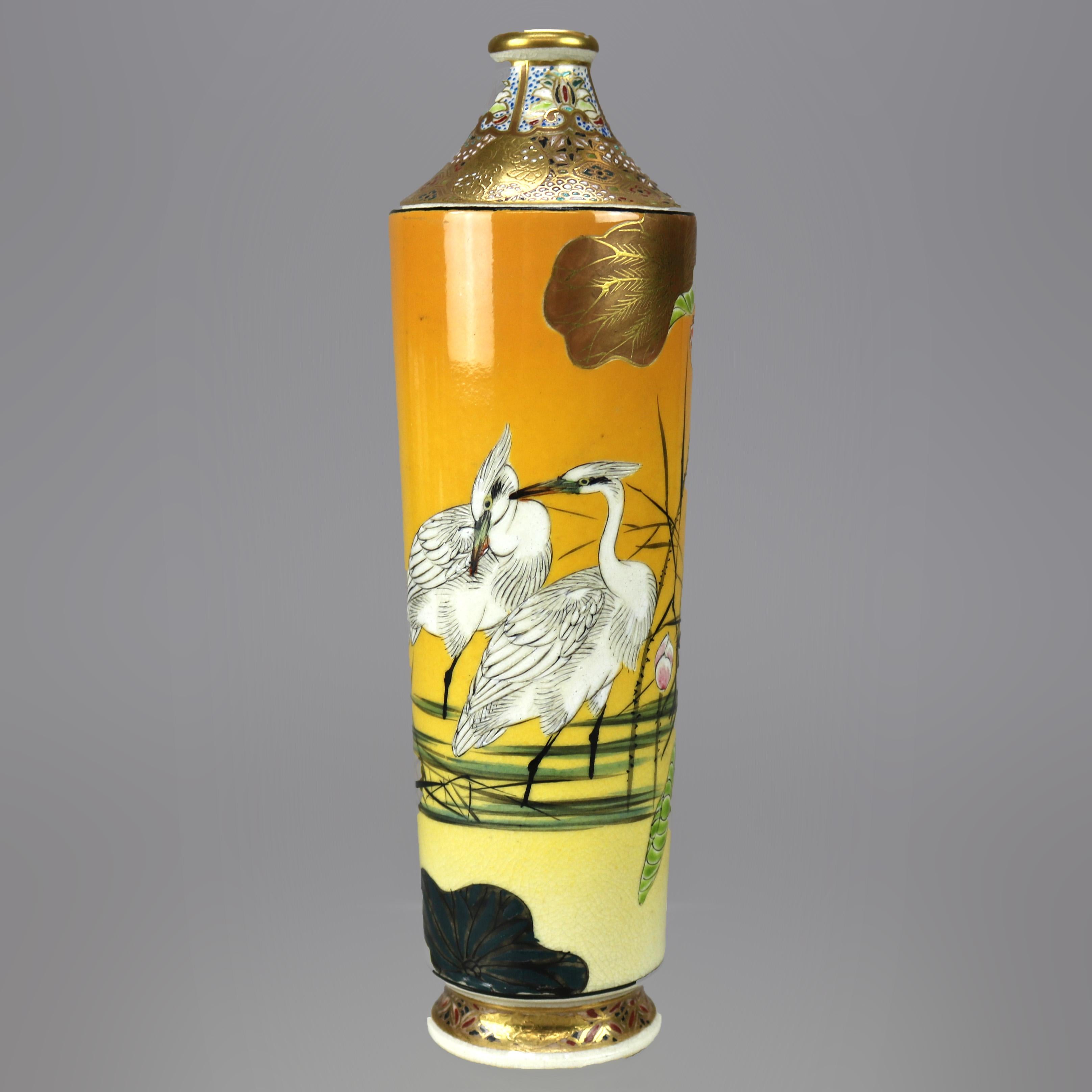 An antique Japanese Aesthetic bottle vase offers porcelain construction with allover hand painted marsh scene having herons, gilt collar with mosaic design, signed on base as photographed, c1900

Measures - 7.25''Height x 2''Wide x 2''Diameter.
