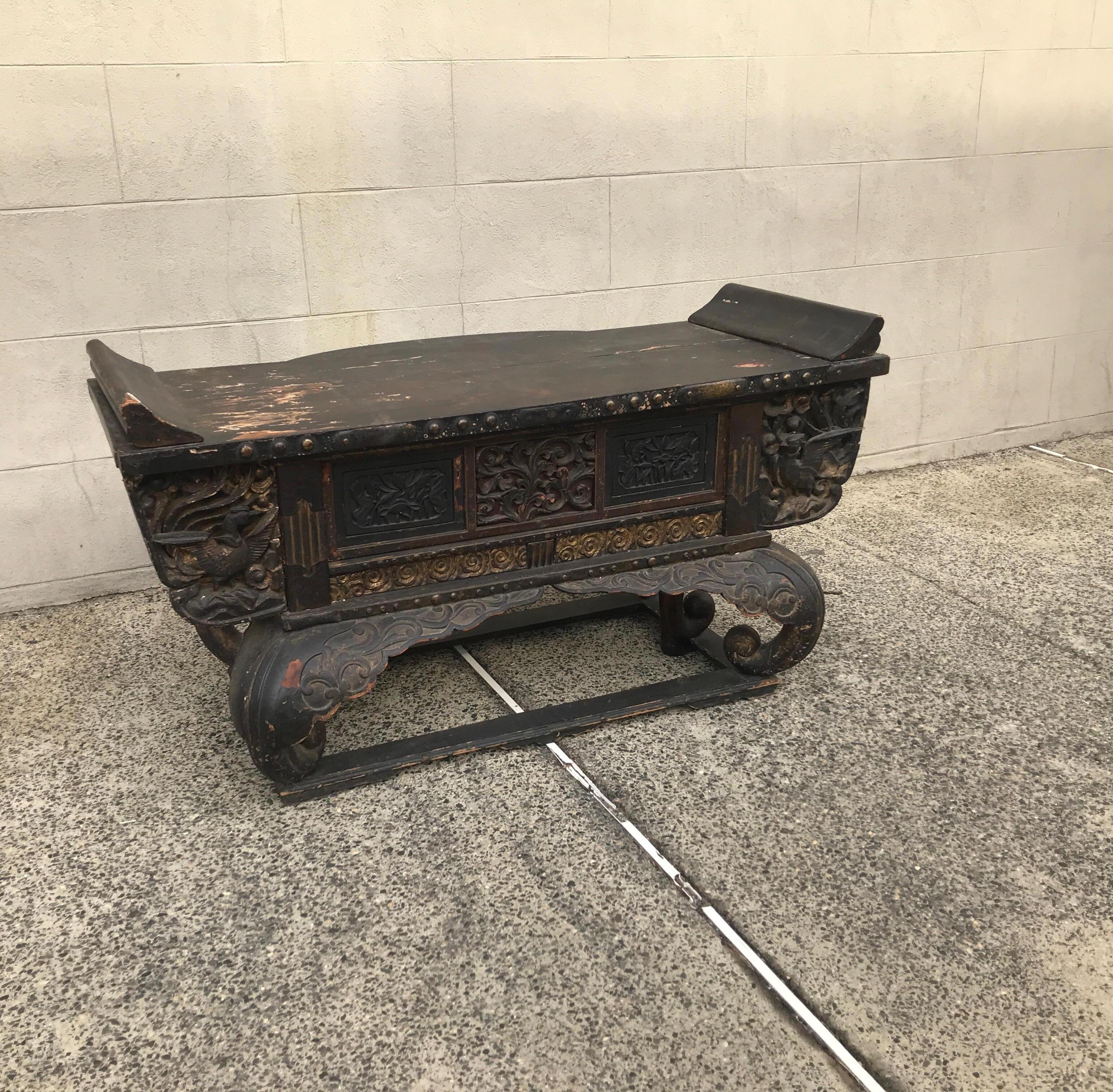 An early circa 1800 Edo period Japanese wood hand carved alter table with drawer. The old surface with some original losses to finish, old restorations with bronze mounts. There are traces of original gilt decoration. The height of the top is 27.5,