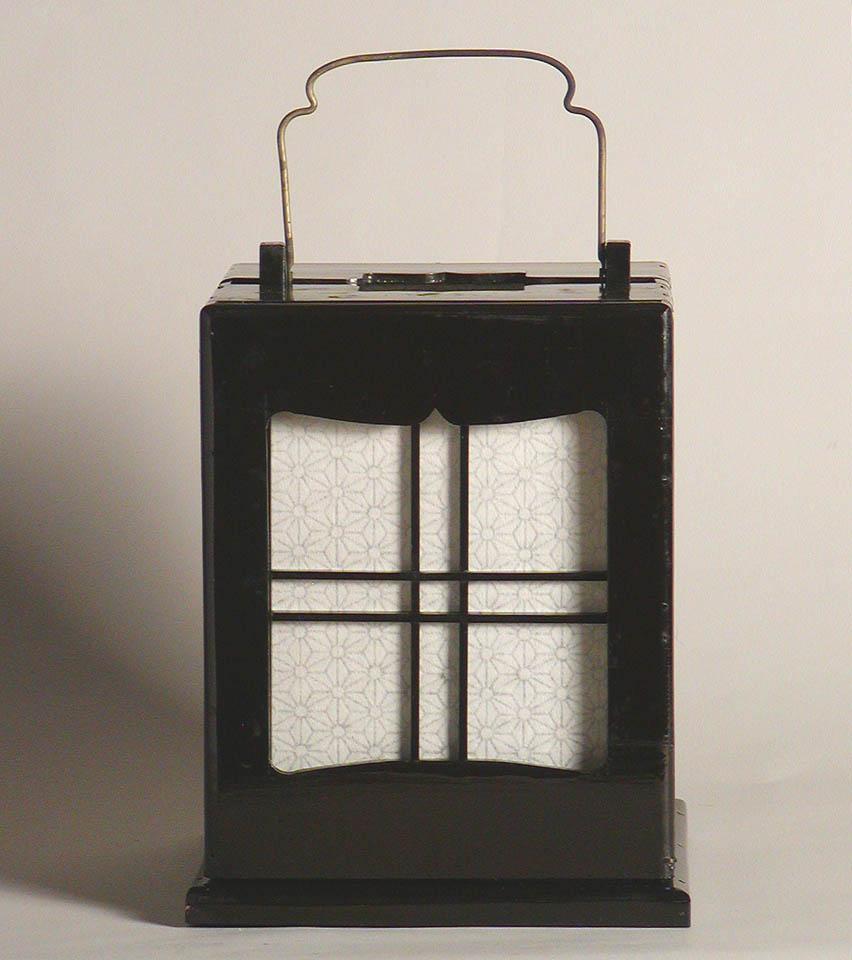 Japanese Ariake Andon, a day break lantern constructed of hinoki (Chaemaecyprus obtusa) lacquered black with front sliding access window and cover having a large rectangular window pane front aperture with curved edges and smaller side window pane