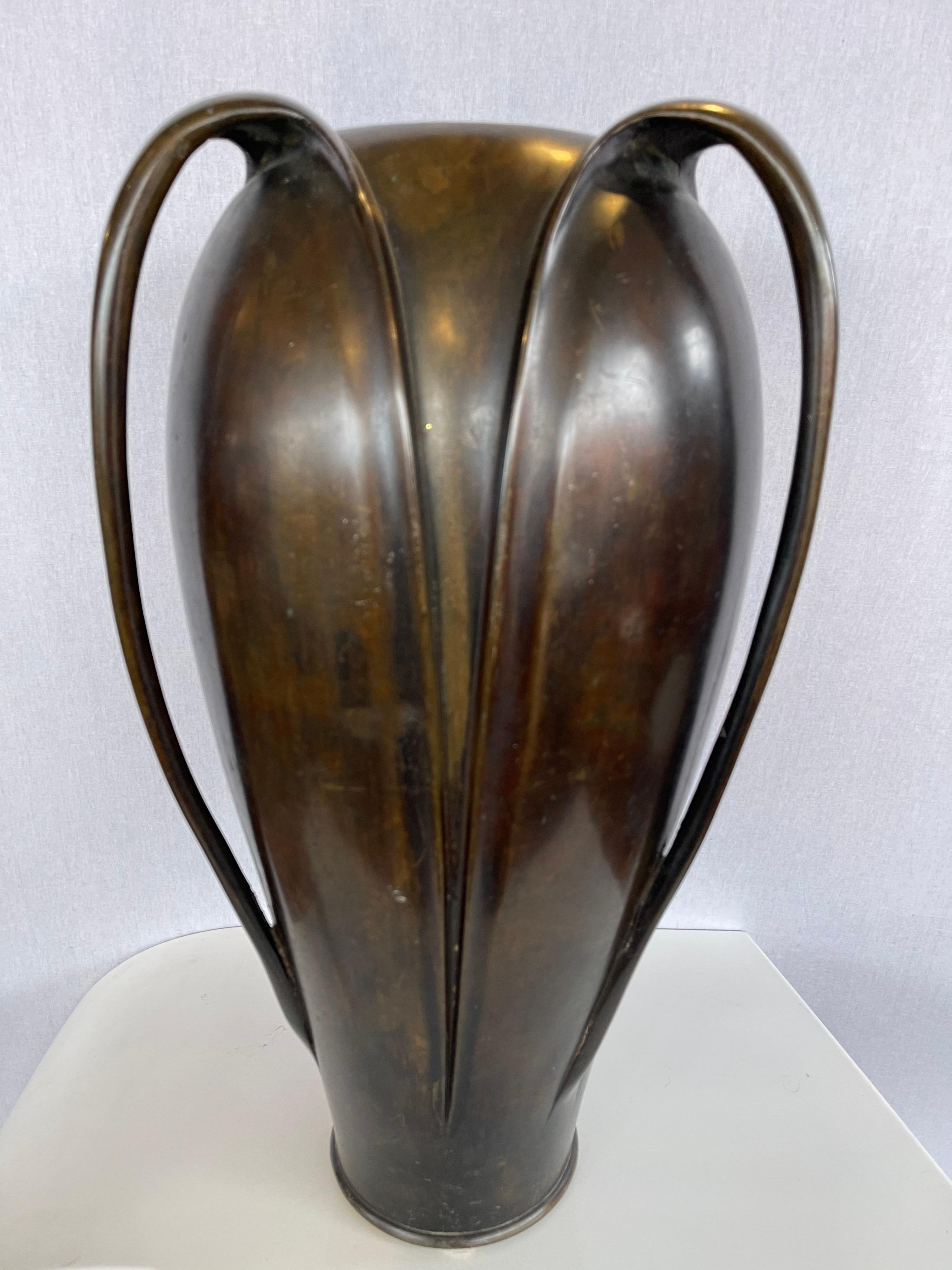 Stunning Japanese Art Nouveau patinated bronze tall vase with lines to die for and unusual tri-handled scheme. Circa early 20th Century.