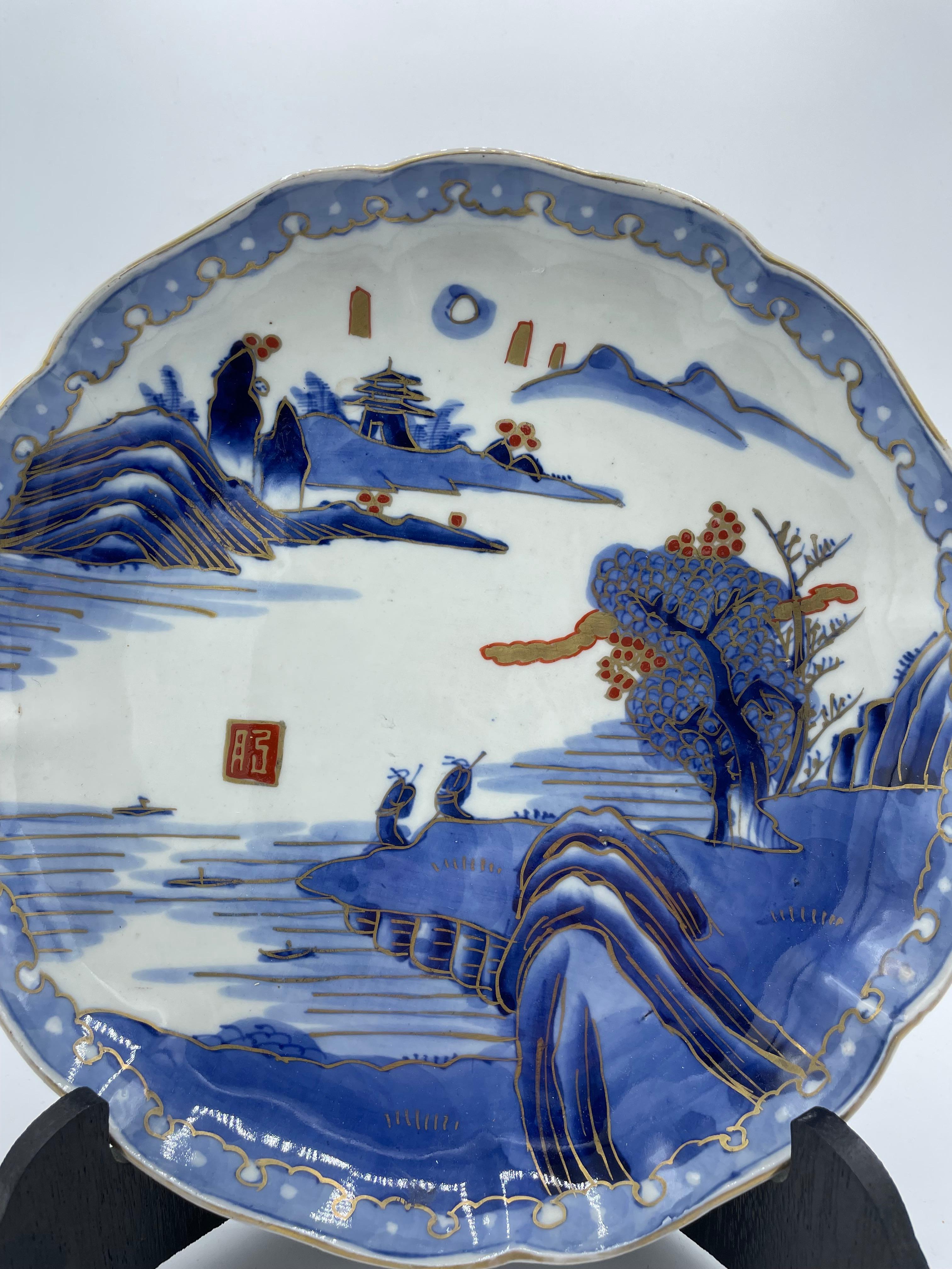 This is a plate which was made in Japan in Taisho era (around 1920s).
It was made with Imari yaki technnique.
This imari plate is made by Gekkyuu, there is a signature on the plate.

Imari ware is a Western term for a brightly-coloured style of