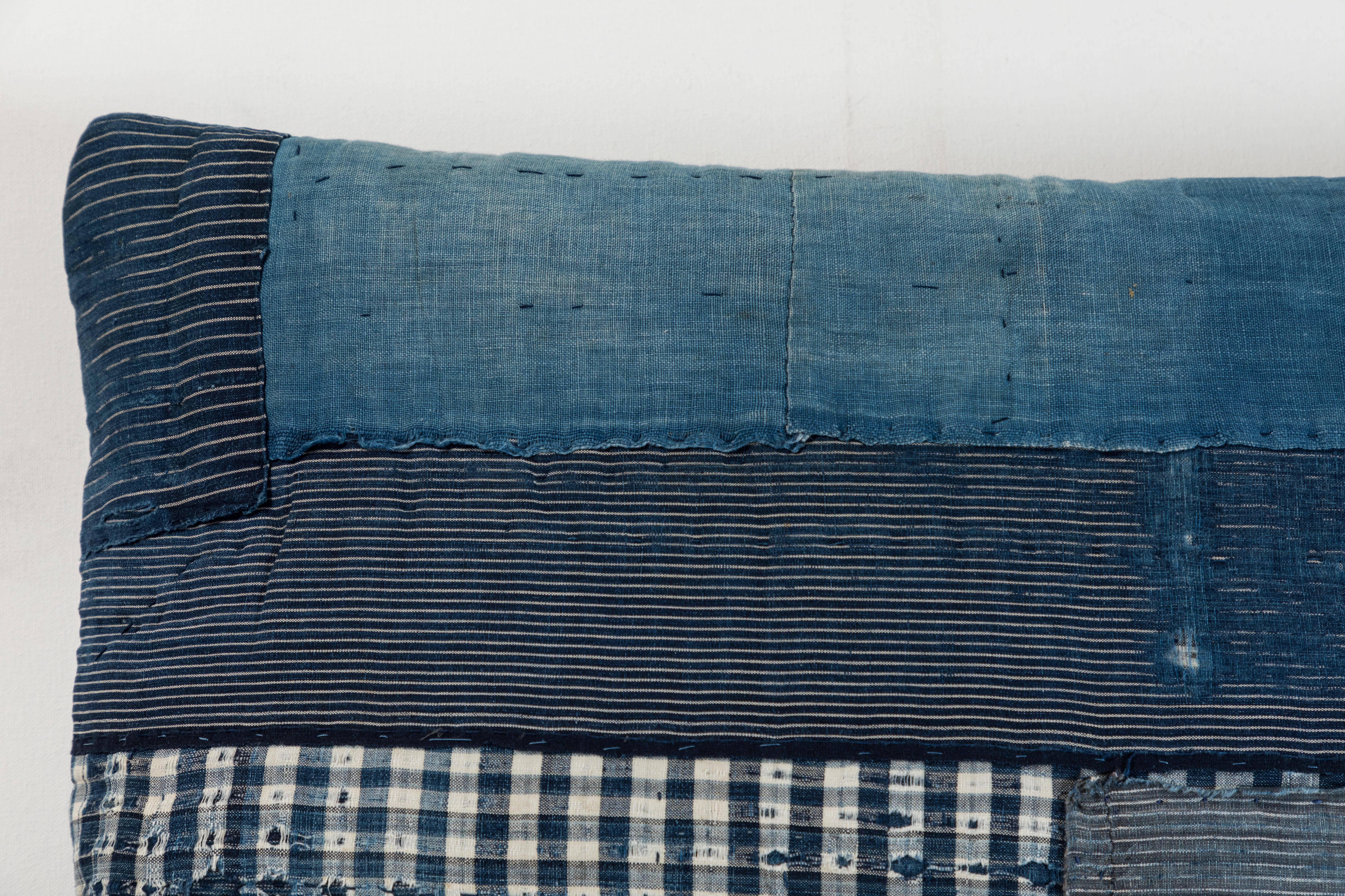 19th century Japanese patchwork indigo cotton reconfigured into a pillow with blue linen back, invisible zipper closure and feather and down fill.

  