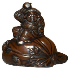 ANTIQUE JAPANESE BRONZE BUDDHA STATUE OF HIM SiTTING ON A SACK POURING WATER