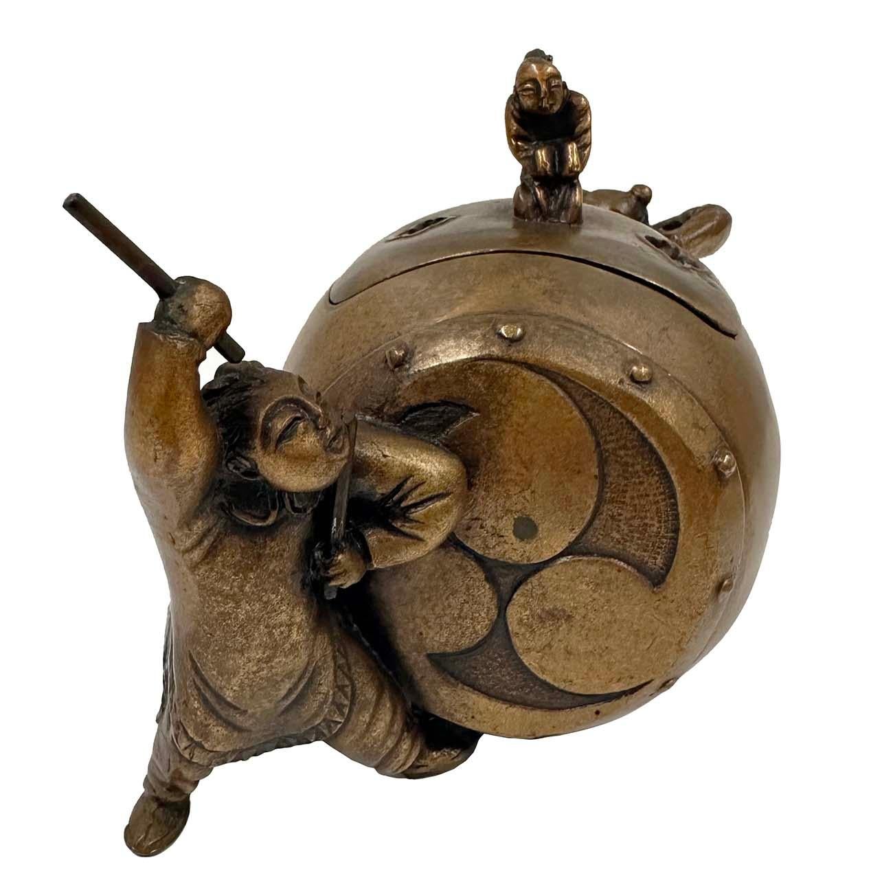 Japanese bronze Koro (Incense Burner) in the form of two kids playing drum. This Koro was hand crafted in about early 20th Century with removable top. It has There is a Tai Chi Diagram on each side of the drum. Two Kids play the drum on both sides.