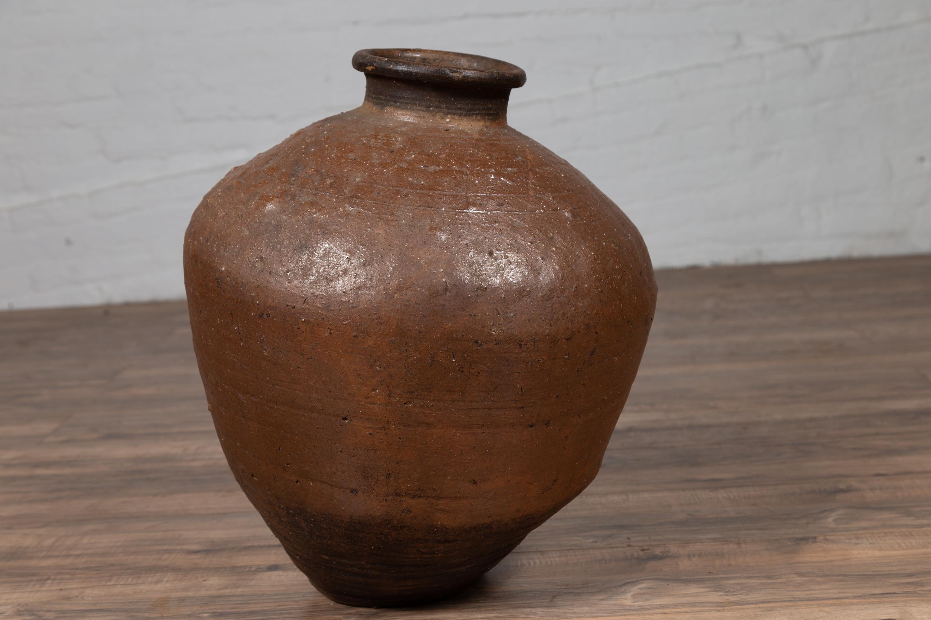 20th Century Antique Japanese Brown Oil Jar with Weathered Appearance and Irregular Shape For Sale