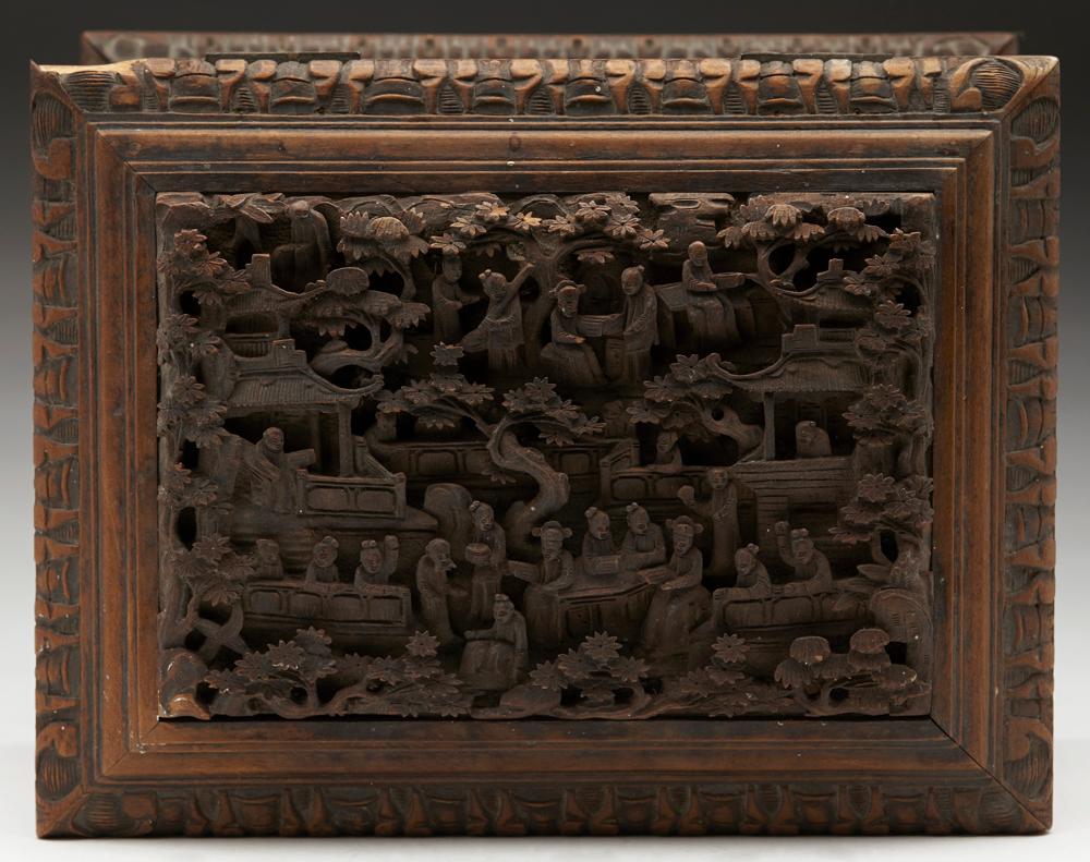 An antique Chinese Canton Qing wooden jewelry box carved in high relief with figural panels and dating from the 19th century. This stunning box of rectangular casket shape stands on a pedestal shaped base with a carved edge and has relief carved