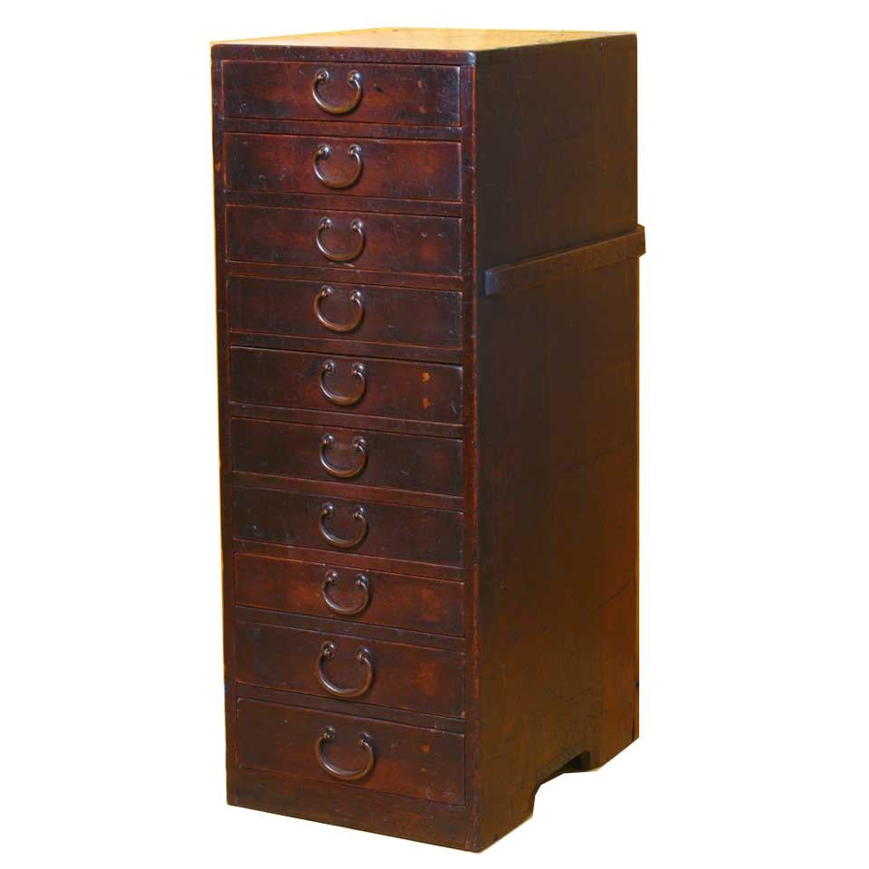 Japanese Carpenter’s tool chest, constructed of Cedar (sugi, Cryptomeria japonica) with a persimmon stain, with the drawer interiors constructed of Paulownia (kiri, Paulownia tomentosa), configured as a stack of ten drawers, the lowest two being