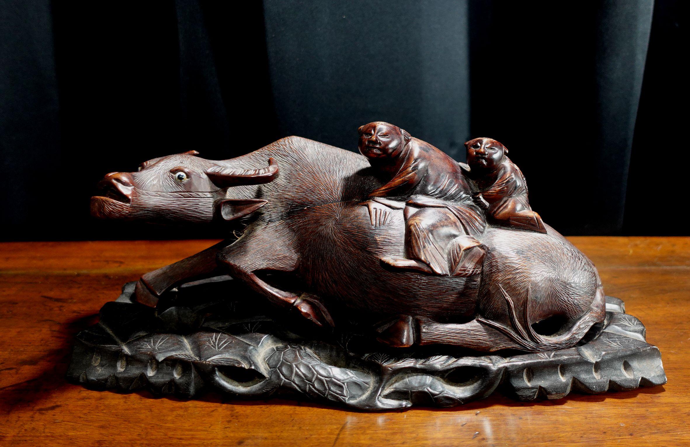 A hand-carved of hardwood, water buffalo, and boys from Japan, depicting two boys seating on the Buffalo back.
The intricated carved on the body of the buffalo presents countless hair, supper quality. The fitted base is also made from hardwood in a