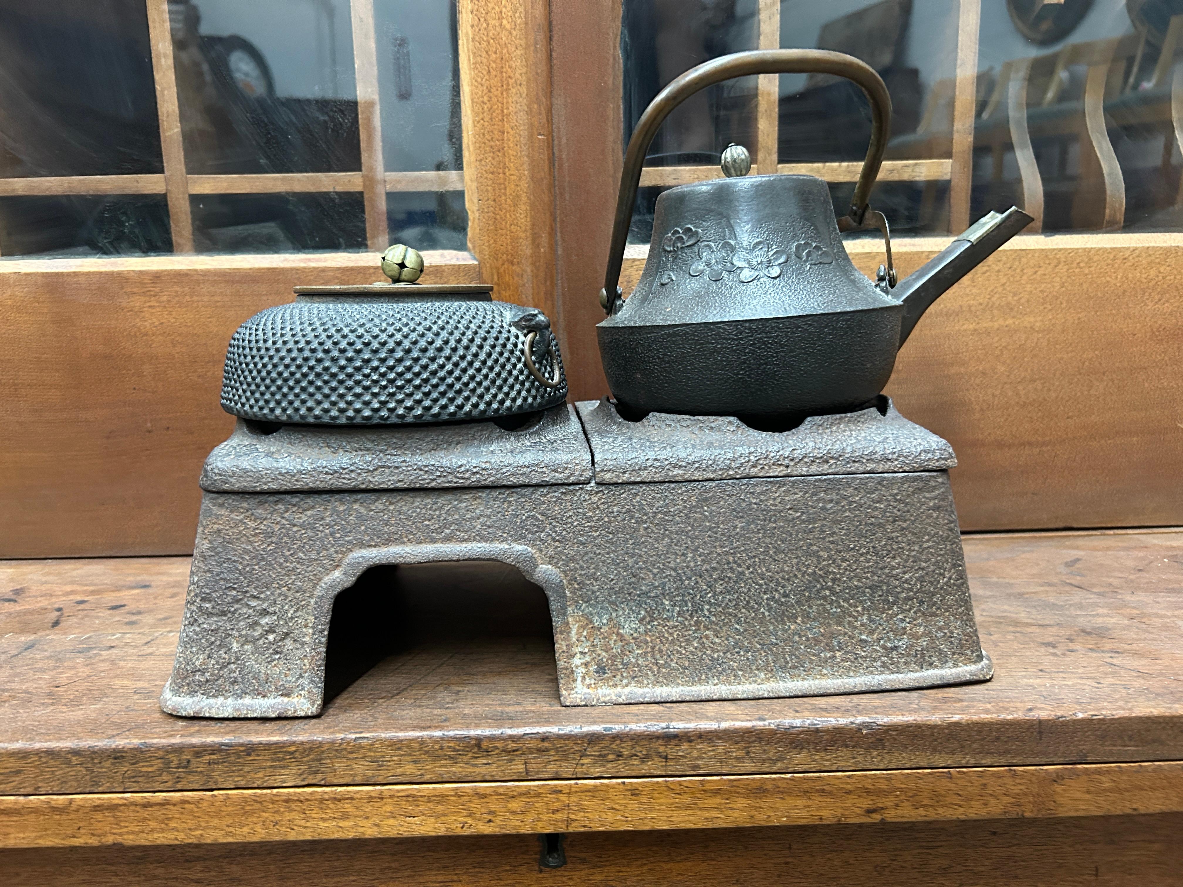 Raro bollitore da tè in ghisa giapponese Tetsubin su supporto hibachi in ghisa. Questa singolare teiera/bollitore è una Tetsubin, ovvero una teiera in giapponese, realizzata in ghisa pesante. Poiché è antico, è meglio utilizzarlo per scopi