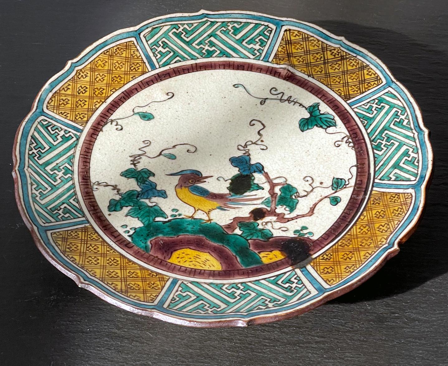 A Japanese glazed ceramic footed dish made in the Ko-Kutani type of Edo period but likely during Kutani revival in the 19th century Meiji Period. The dish with delicate foliaged rim is raised on a circular foot with cutout design. The piece is