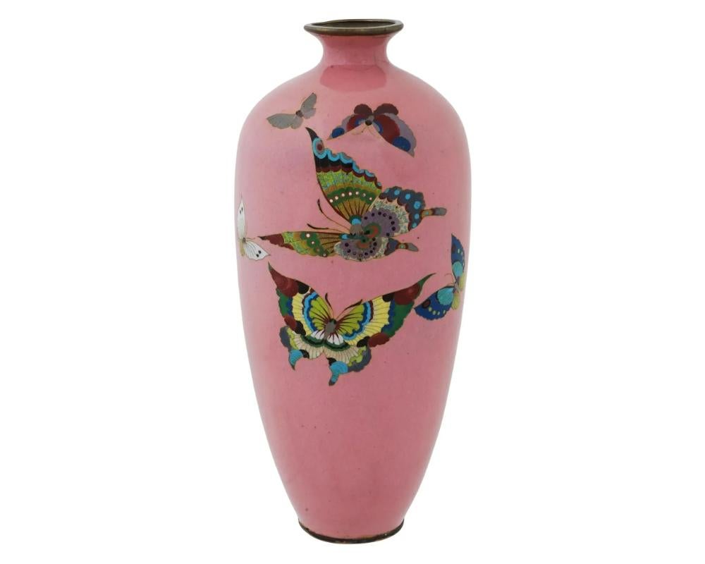 An antique Japanese, late Meiji era, enamel over copper vase. The urn shaped vase is adorned with a polychrome image of butterflies against a bright pink background made in the Cloisonne technique. Unmarked. Circa: late 19th century
Dimensions: H 9