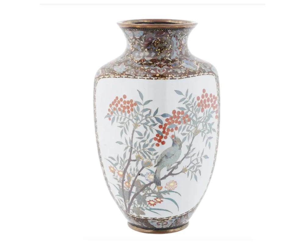 A large antique Japanese copper vase with cloisonne enamel design. Late Meiji period, before 1912. A medallion with butterflies among peony flowers is presented on the front side, a picture of a bird on a rowan branch on the verso side. The panels