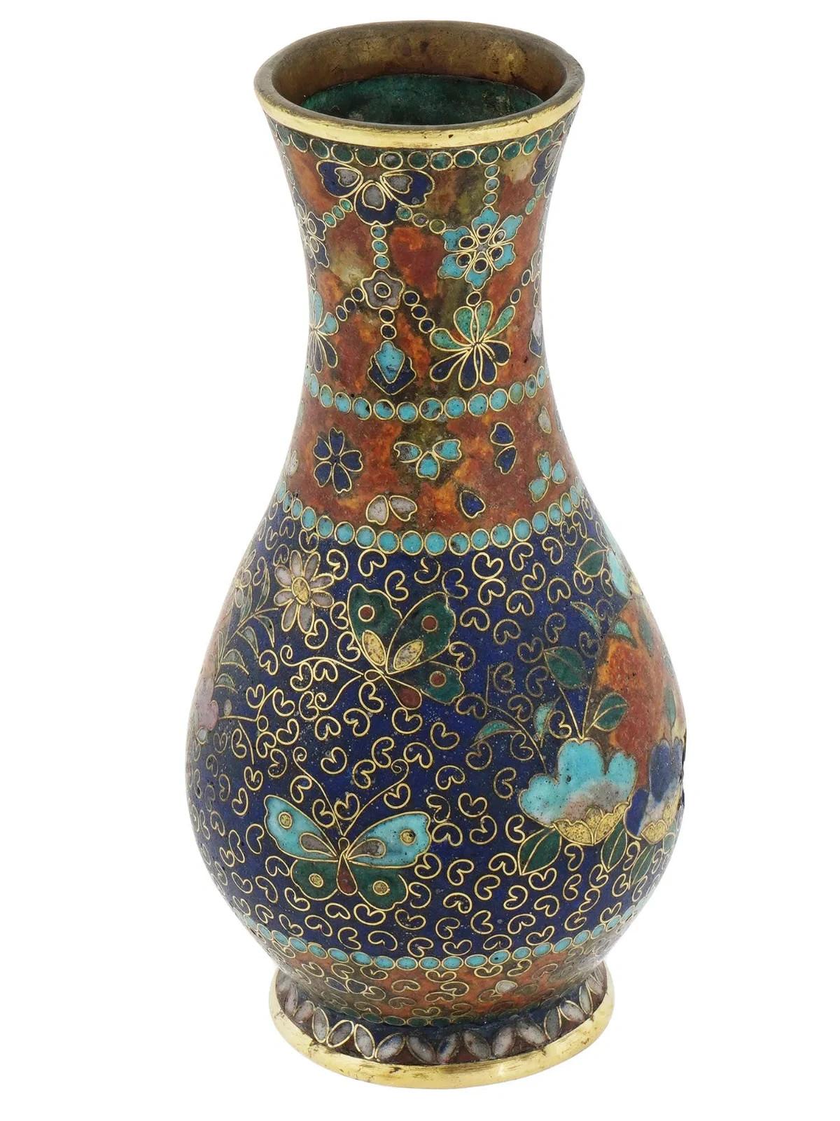 An antique Japanese early Meiji period cloisonne vase, attributed to the renowned artist Namikawa Yasuyuki. Adorned with intricate floral motifs, delicate butterflies, and exquisite beaded detailing, this vase showcases the meticulous artistry