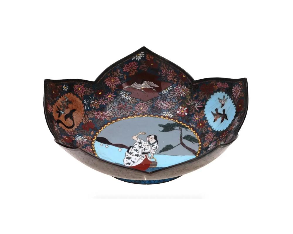 An antique Japanese cloisonne enamel bowl crafted during the Meiji period. The bowl is designed in the shape of a lotus flower, a revered symbol of purity and enlightenment in Japanese culture. The intricate enamel work adorns the interior depicting