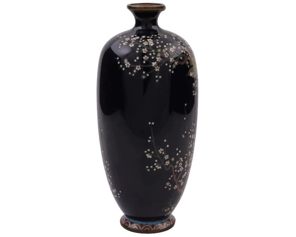 An antique Japanese copper vase with polychrome cloisonne enamel decor. Late Meiji period,
attributed to Hayashi
Elongated baluster shape. Intricate cherry blossom and bird motif against the black background. Patterned base. High quality.