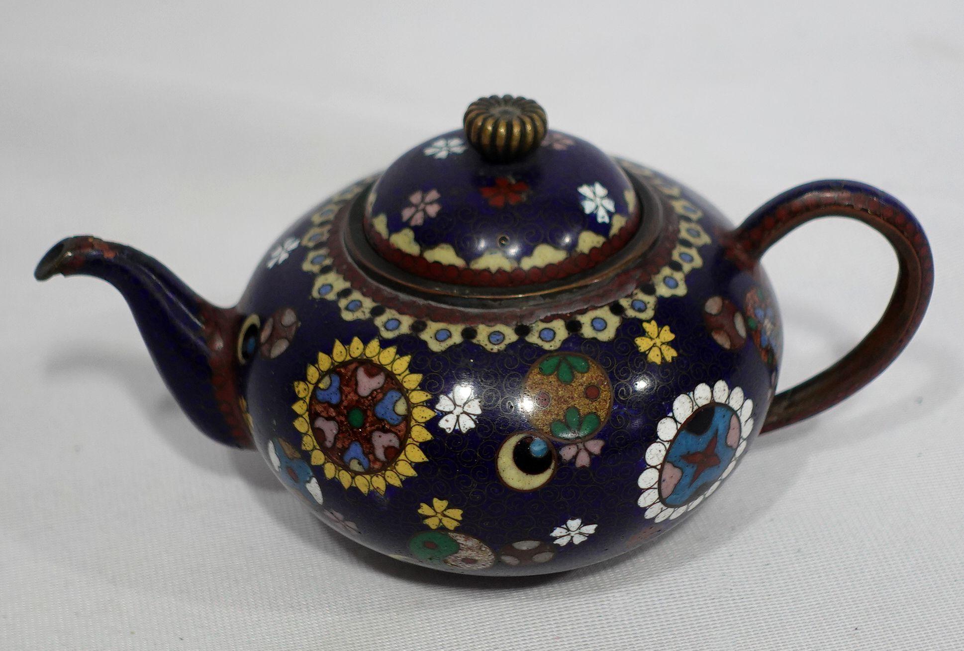 Quality work, amazing workmanship with absolutely fine details bronze cloisonné enameled teapot depicting the scene of floral and Yin Yang patterns with vivid colors of yellow, light golden green, red, blue, brown, and gold.
