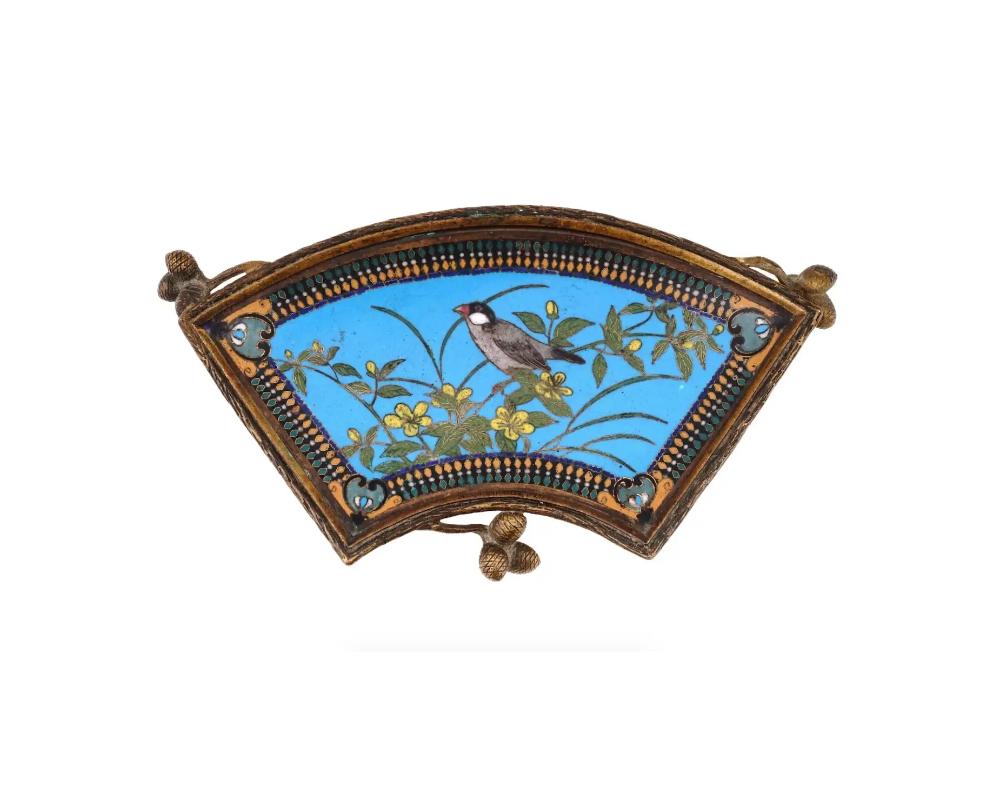 An antique Japanese Meiji period tray. Features a vibrant and detailed depiction of a bird and a scrolling pattern backside, created using the cloisonne technique. The tray is further enhanced by its French ormolu mounting with pinecones. Circa the