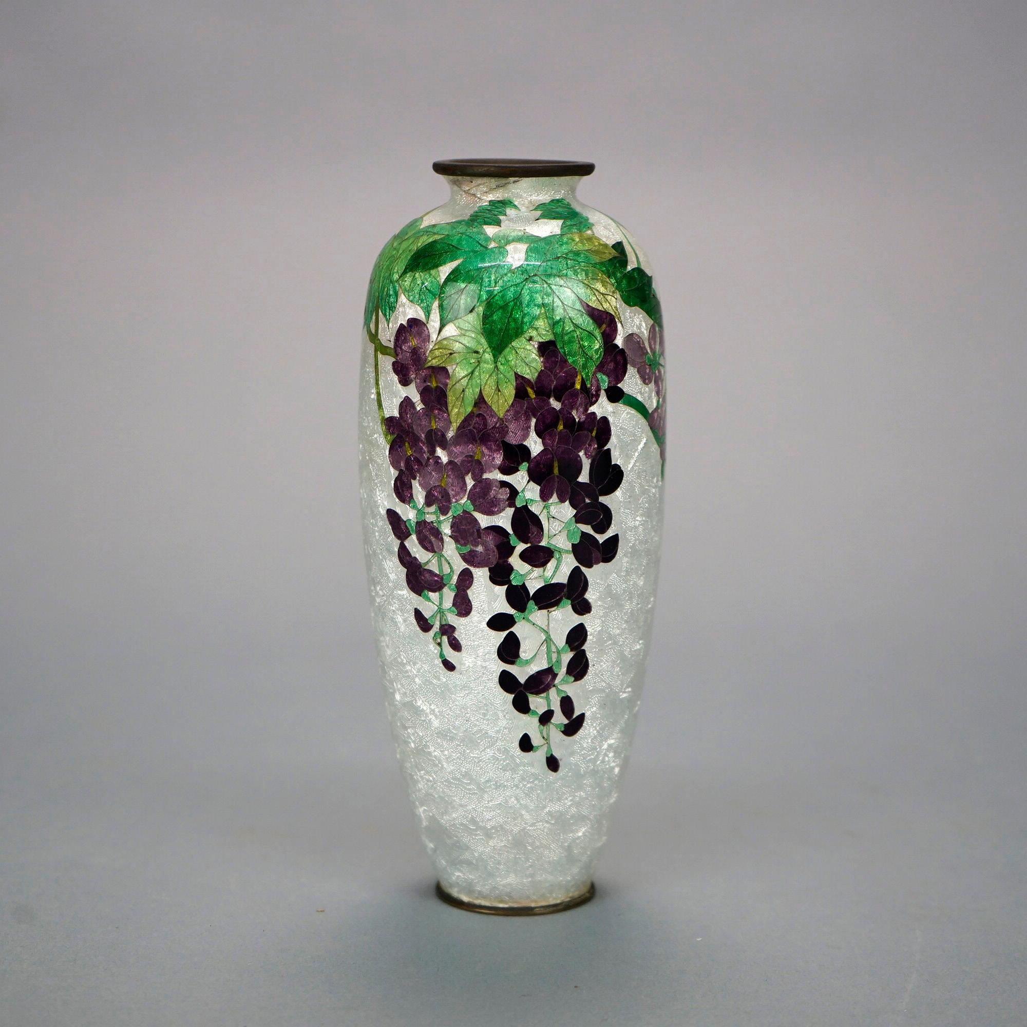 An antique Japanese Meiji vase offers Cloissone enameled flower decoration, c1900

Measures- 7.5''H x 3''W x 3''D