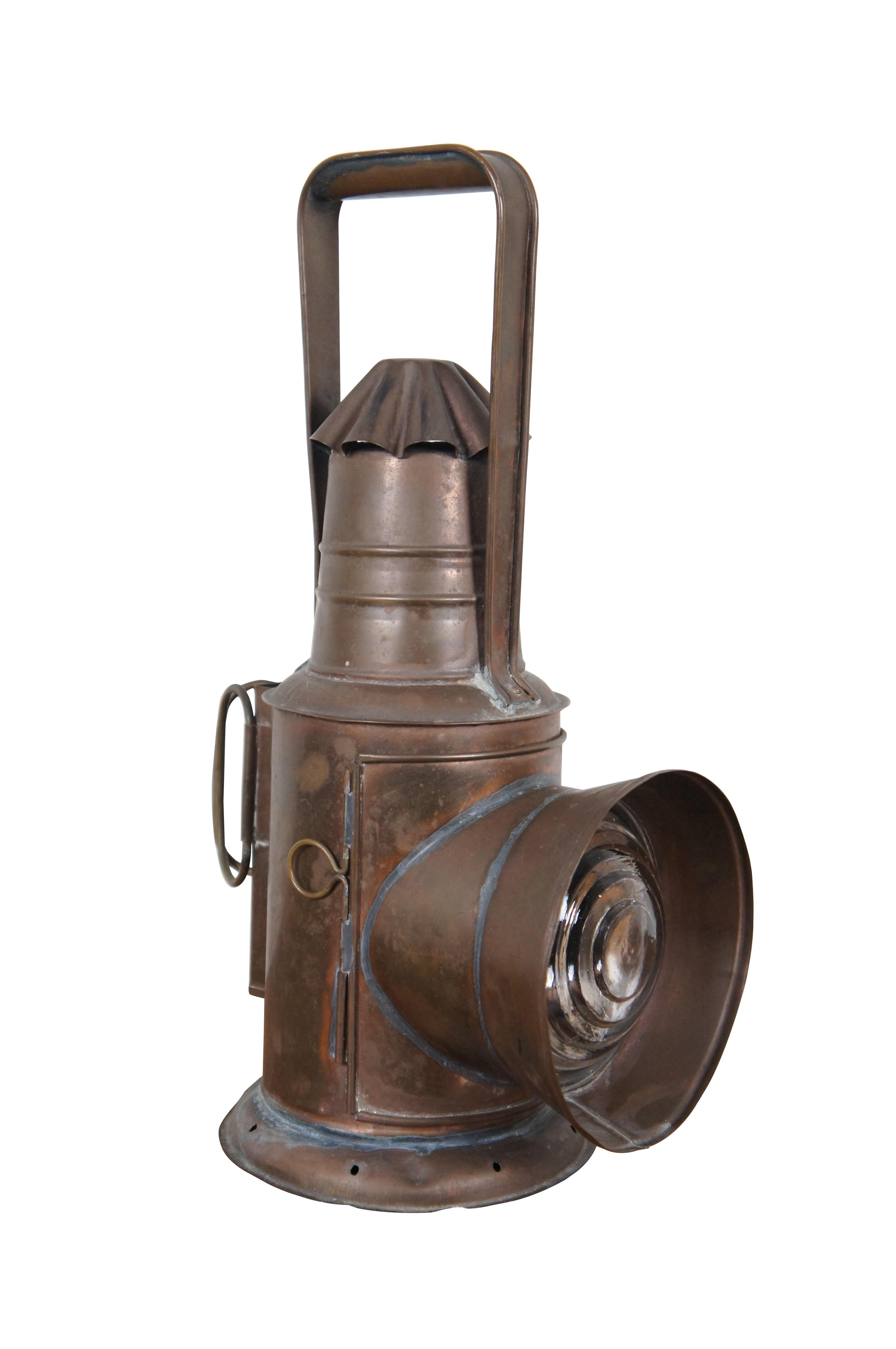 Antique copper police/ railroad / boat signal lantern / hand lamp. Features cylindrical body style, fluted cone shaped chimney top, and rear handles of a typical dark lantern but no internal shutter for hiding the light. Fixed rectangular bail