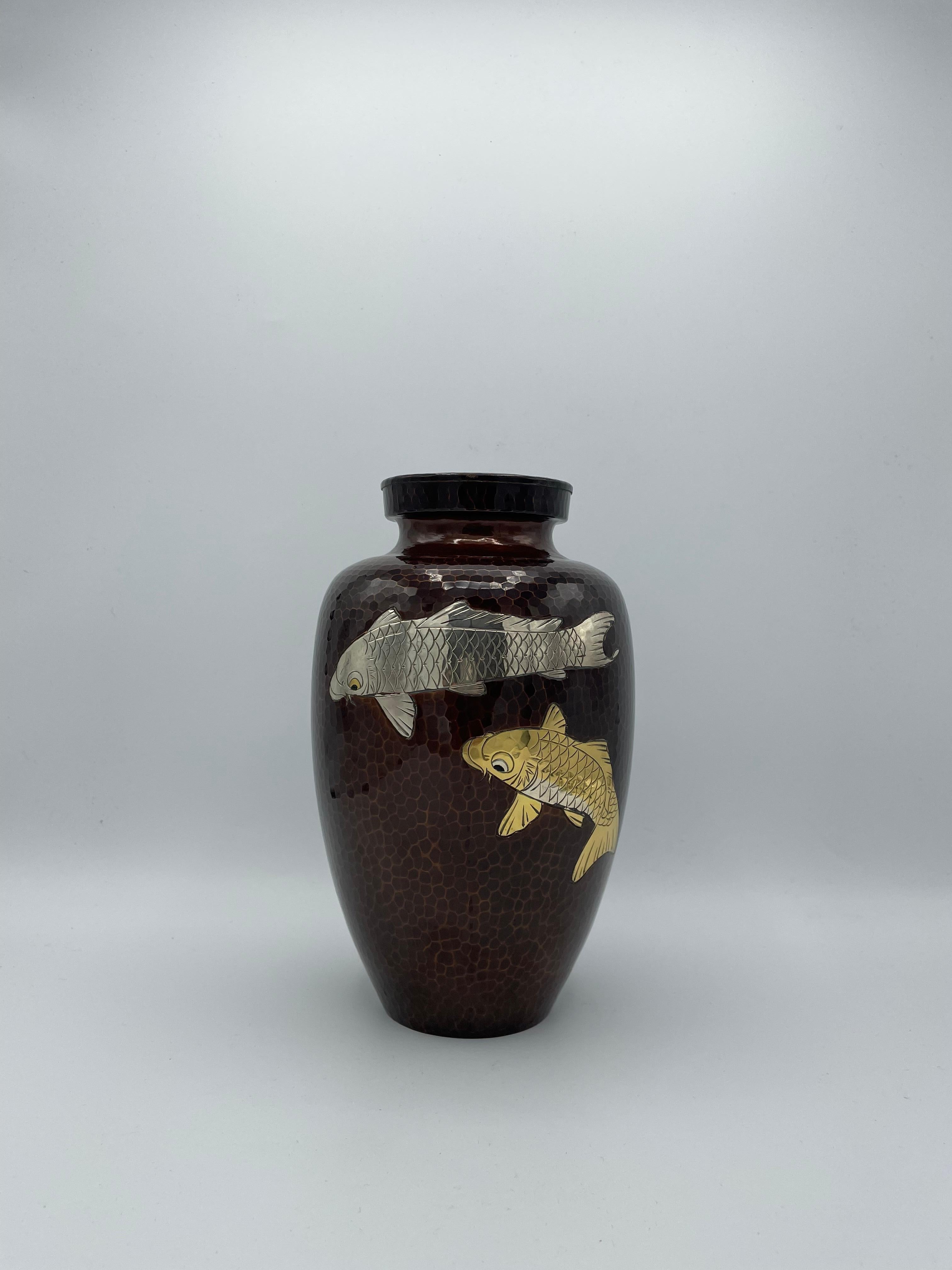This is a flower vase made in Japan around 1980 in Showa era. It is designed with two carps in gold and silver. 
This style made with copper is called Shippou in Japanese.
The cloisonné technique was mastered in China in the early 19th century and