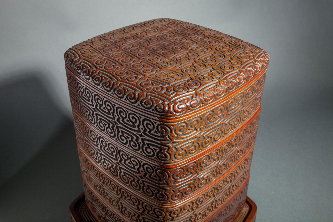Antique Japanese dramatically carved and lacquered stack box on stand. Meiji period (1868 - 1912) lacquer stacking box, traditionally used for bringing mochi (rice cake) to celebrations.
