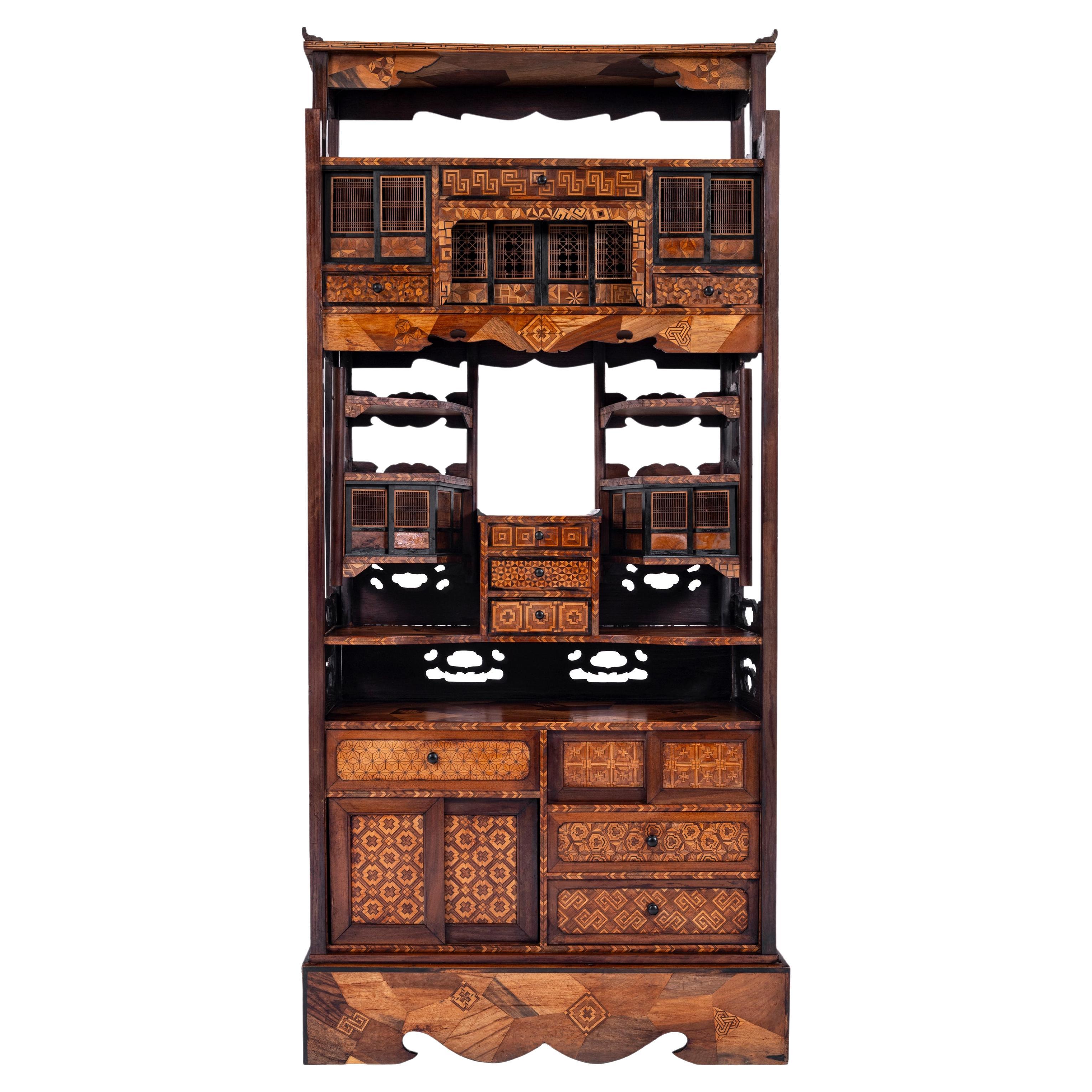 A very fine antique Japanese Meiji period marquetry (Yosegi Zaiku) cabinet/etagere cabinet (Shadona), circa 1880.
The cabinet of unusually large Size; as many of these cabinets are much smaller and often this style of Japanese marquetry was used on