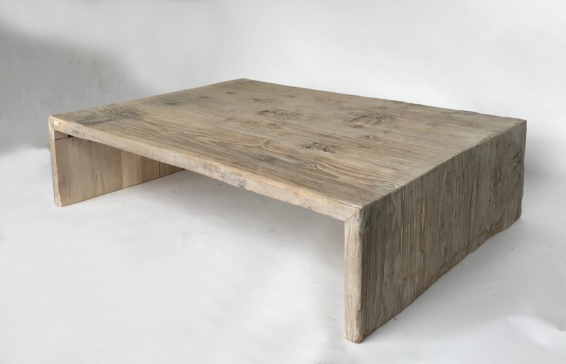 200 year old Northern Japanese Elm fashioned into a rustic modern waterfall/Parsons coffee table. There are original pieces of hardware and nails, as well as imprints from old hardware taken off. Beautiful, naturally weathered wood, with knots and