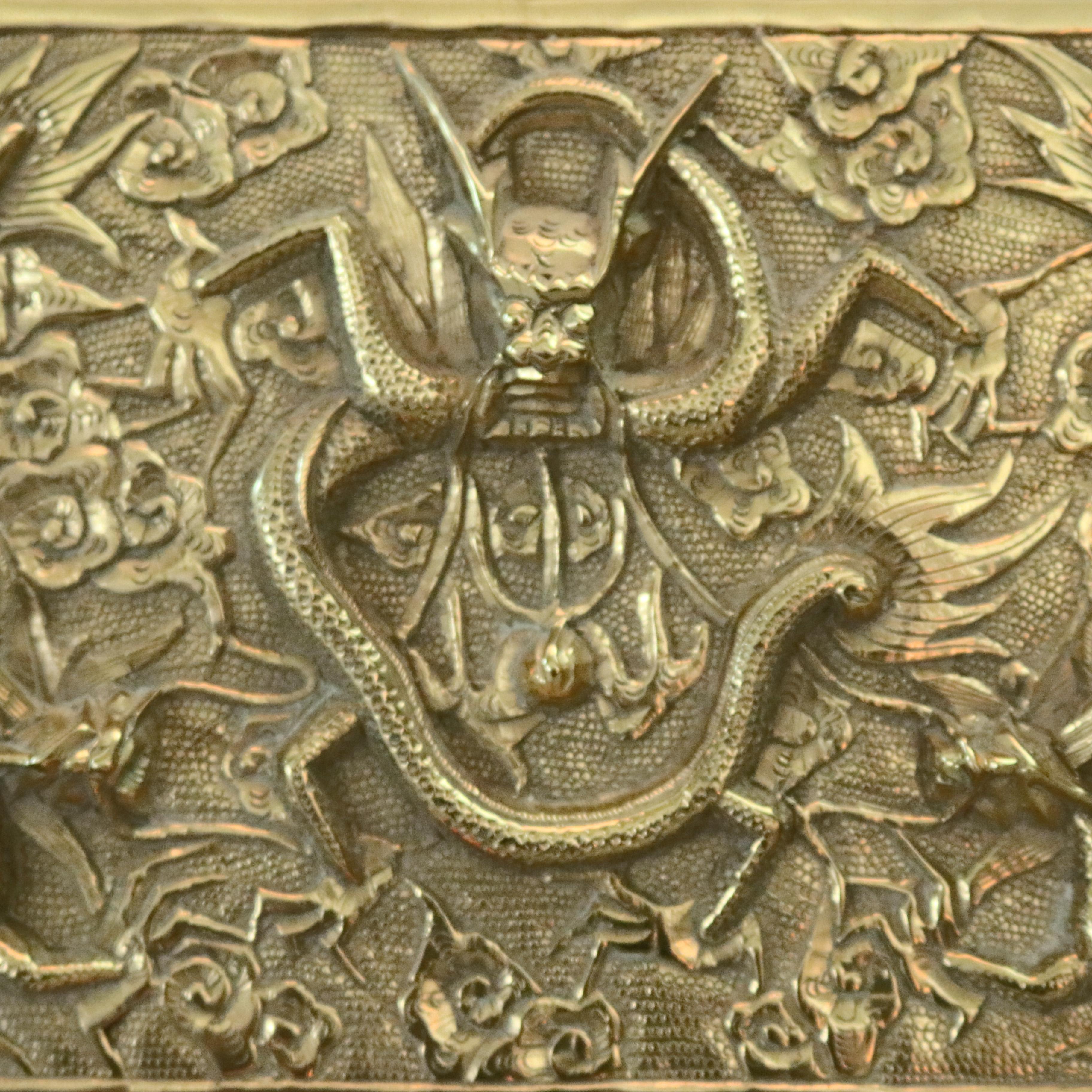 An antique Japanese figural document box offers cast bronze footed case with hinged lid and having relief design including Oni or Hannya devil mask, serpents, dragons, floral and foliate design, circa 1930.

Measures: 4