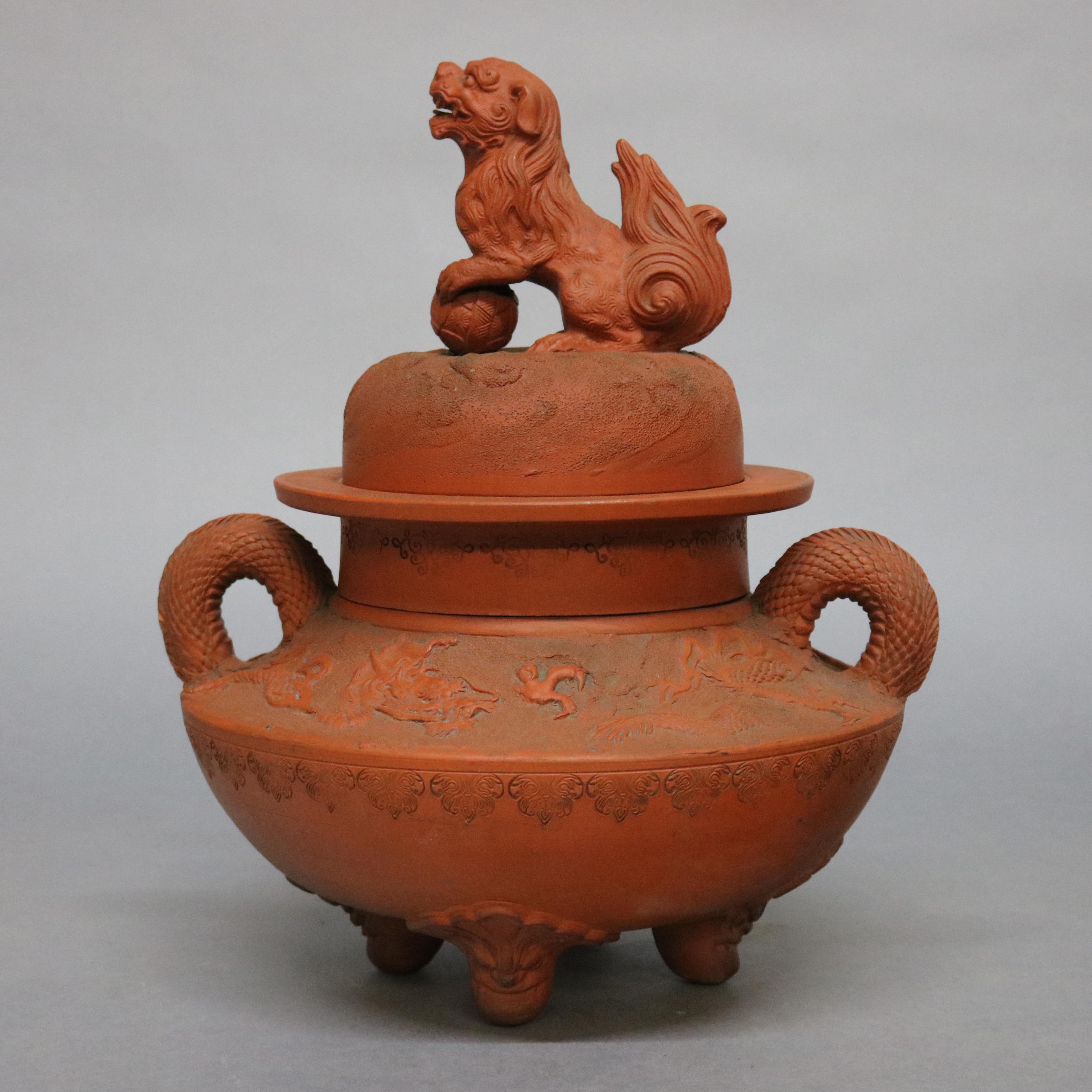 An antique and large Japanese censer offers urn form with foo dog finial on lid surmounting urn with removable basket weave collar, double serpent handles and having dragon relief design, stamped on base as photographed, circa 1900

Measures: 15