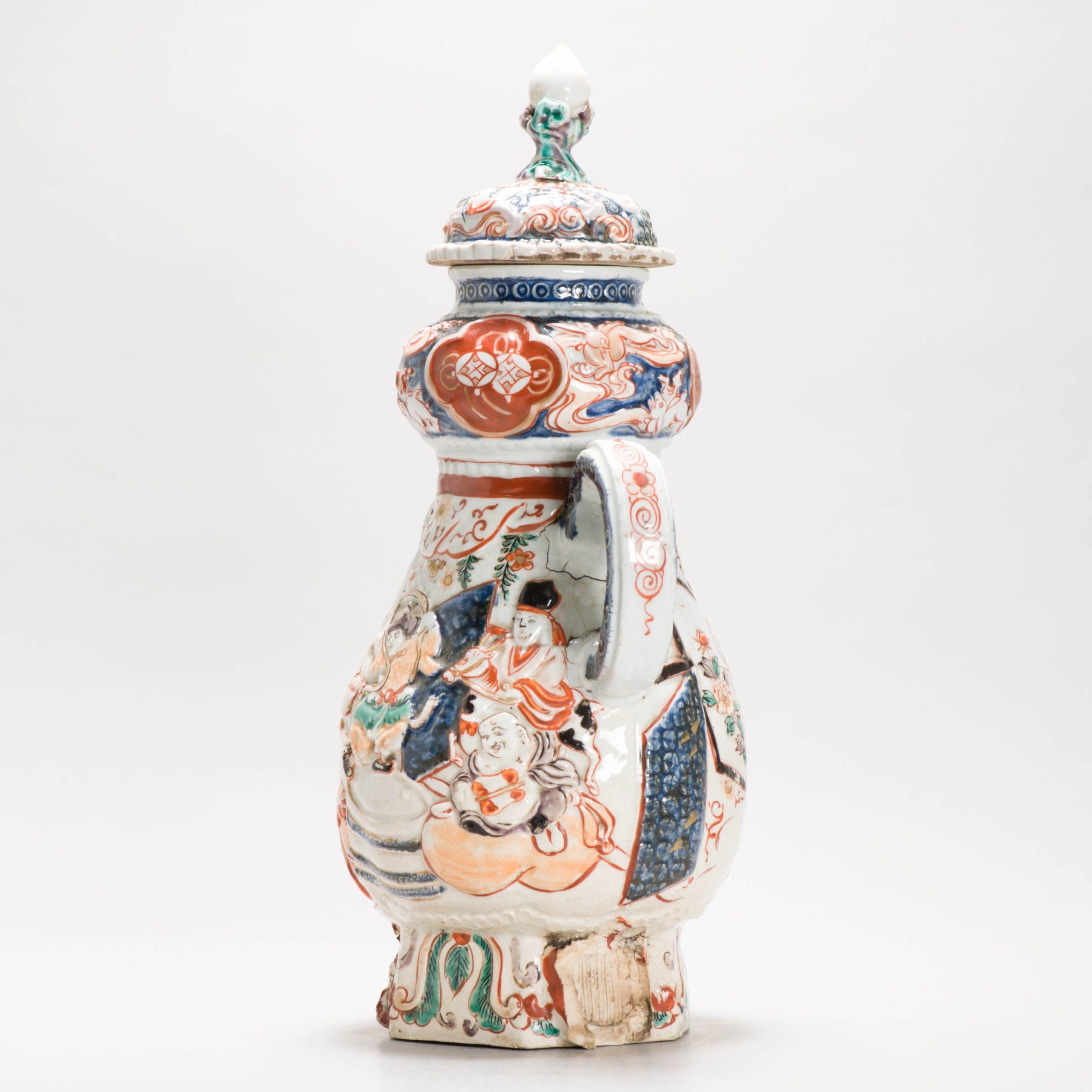 An Imari Coffee Pot and Cover
Edo period (late 17th century)
Of typical form, moulded and decorated in iron-red, green, aubergine and black enamels and gilt on underglaze blue with a party of the Seven Gods of Good Fortune, Shichifukujin, amongst