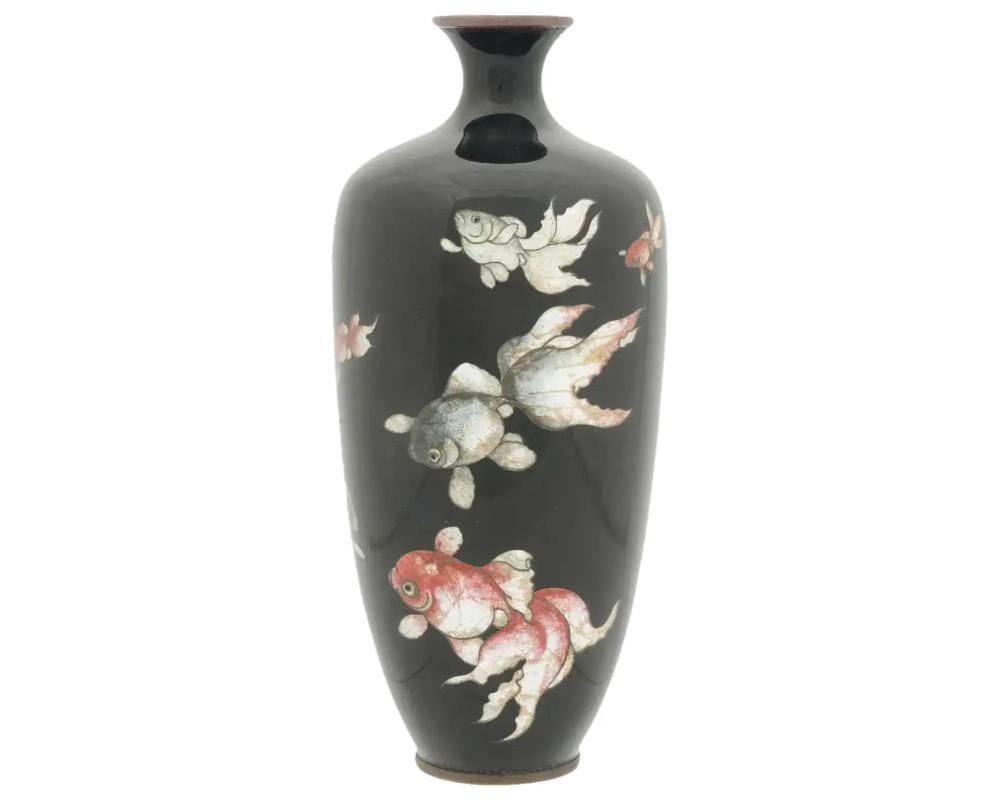 An antique Japanese Meiji period Ginbari enamel vase.
The ground of the vase is enameled in a black shade.
The vase is enameled with polychrome images of fish made in the Cloisonne technique.

Ginbari is a Japanese cloisonne technique when clear