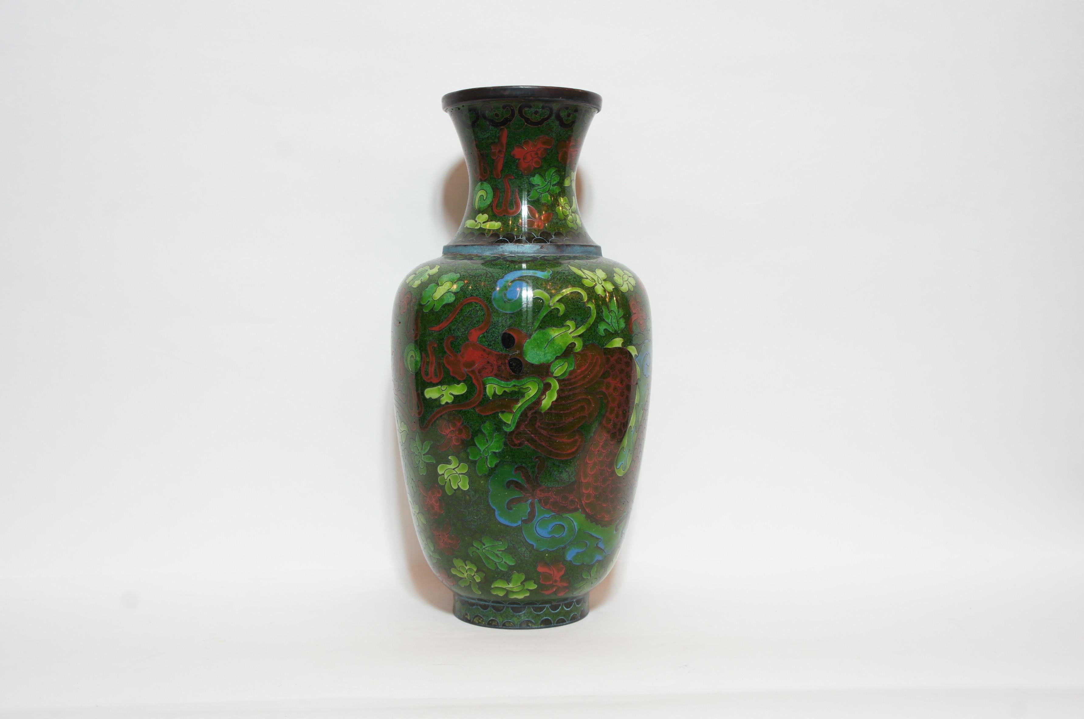 This is a green and red flower vase made in Japan around 1860 in Edo era. It is designed with a dragon and flowers. 
This style made with copper is called Shippou in Japanese.
The cloisonné technique was mastered in China in the early 19th century