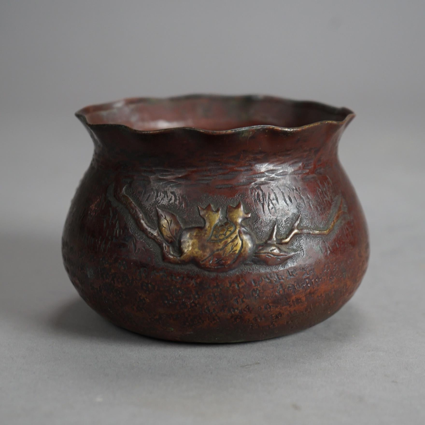 An antique Japanese bowl offers hammered copper and mixed metal construction with additional mixed metals, ruffled rom and embossed fruit and branch element, c1900

Measures- 3.5''H x 4.75''W x 4.75''D
