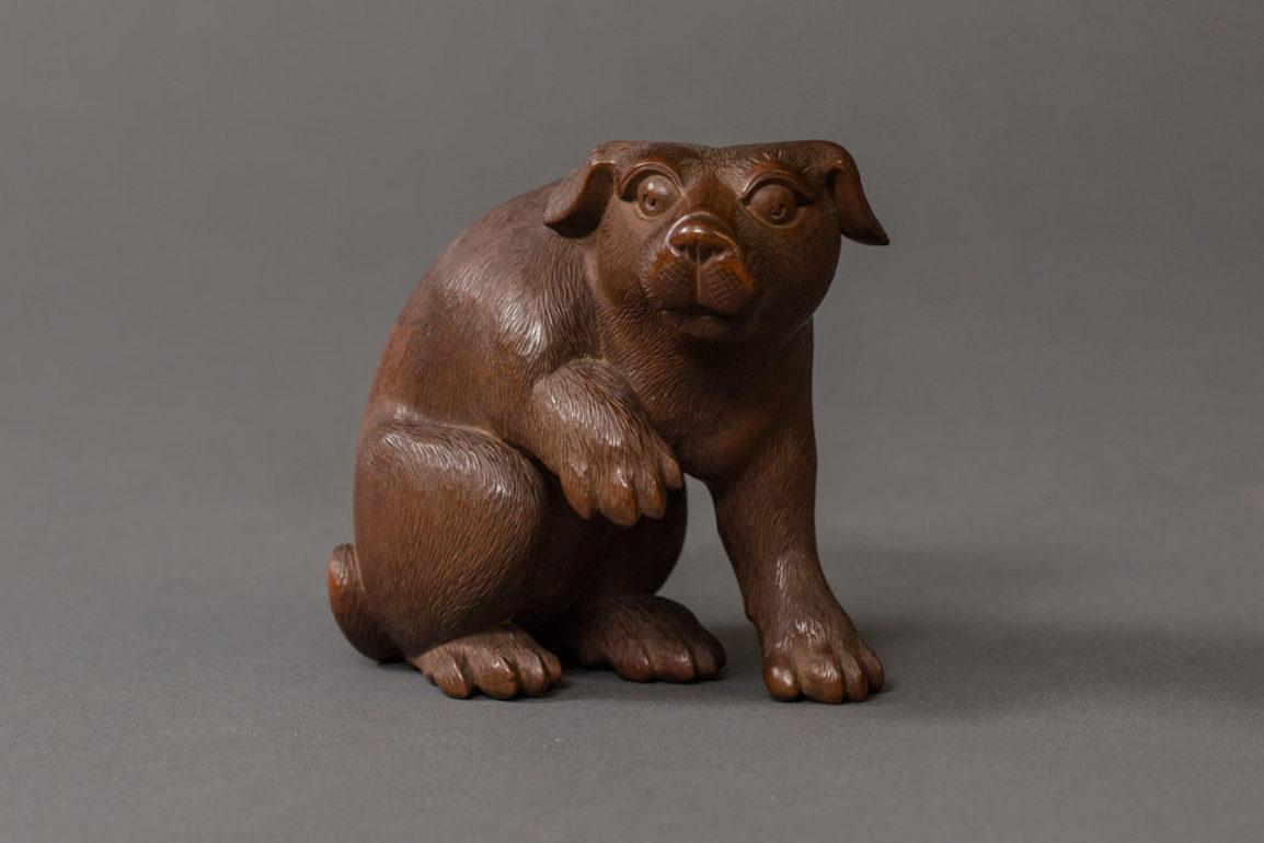 Antique Japanese hand carved puppy.  Expertly carved, showing a poised and alert puppy. Comes in original storage box with dedication, artist signature and collector's seal. Dedication reads: Puppy was purchased by a collector in 1940 for