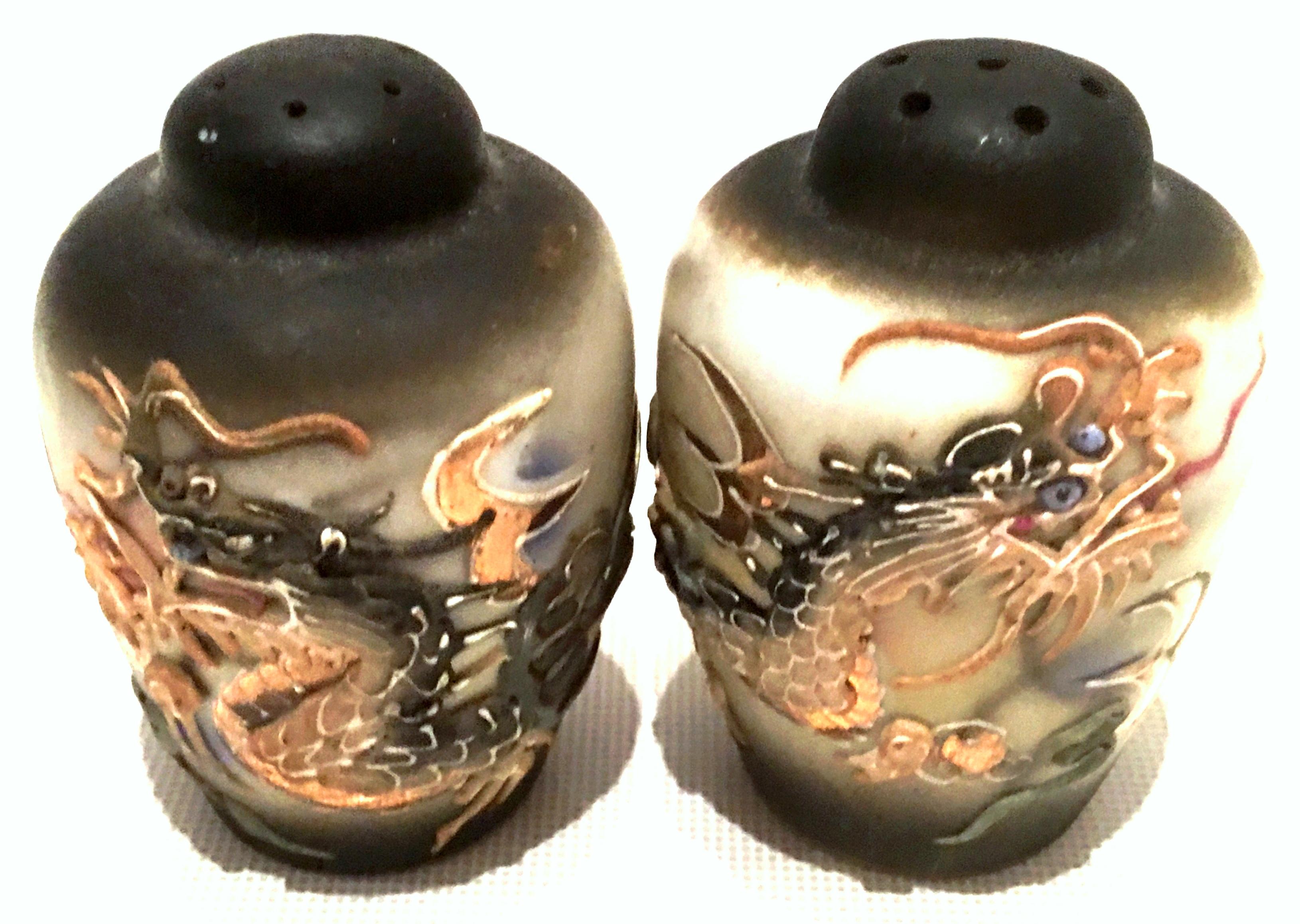 1920s Japanese pair of hand painted porcelain Moriage 22-karat gold dragon ware salt and pepper Shaker's. Features cork stoppers, signed on the bottom, made in Japan.