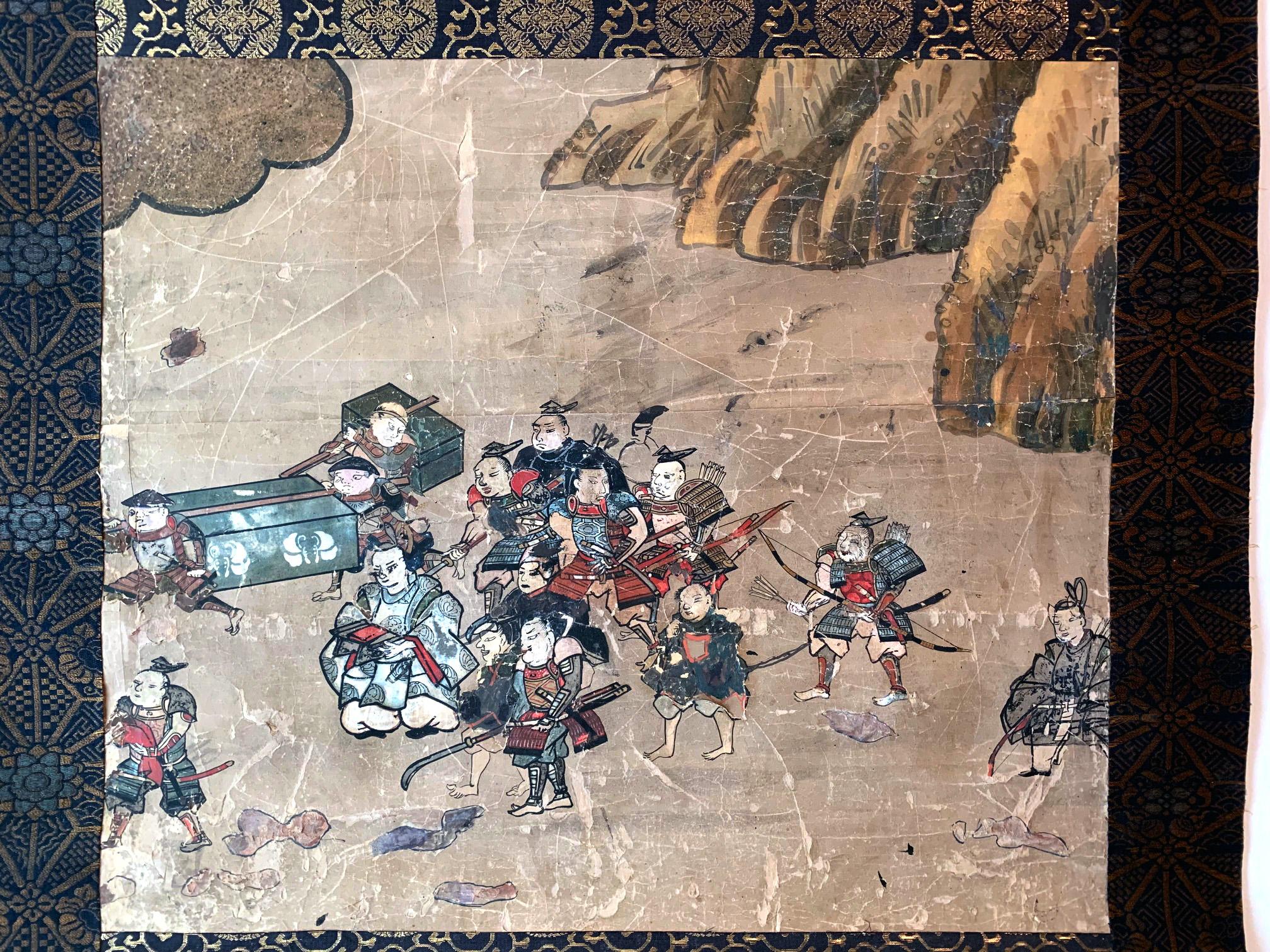 An antique ink and color on paper hanging scroll (kakejiku) with brocade border. It appears to be a fragment of a larger hand scroll depicting a procession of a lord with his entourage. In his full regalia, the lord is carried in his sedan chair and