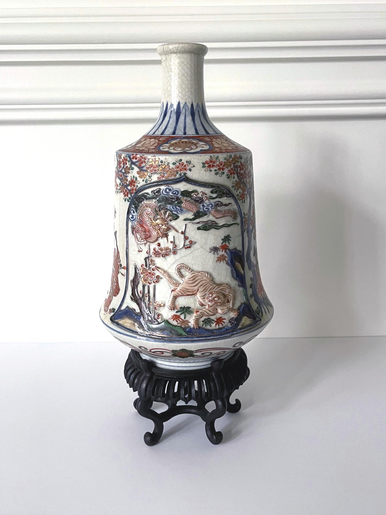 On offer is a large Japanese Imari ceramic bottle vase with elaborate surface design circa 19th century (late Meiji Period). The distinct shape of the bottle is called tea-whisk form and the rare prototype was found in the early Ko-Imari production