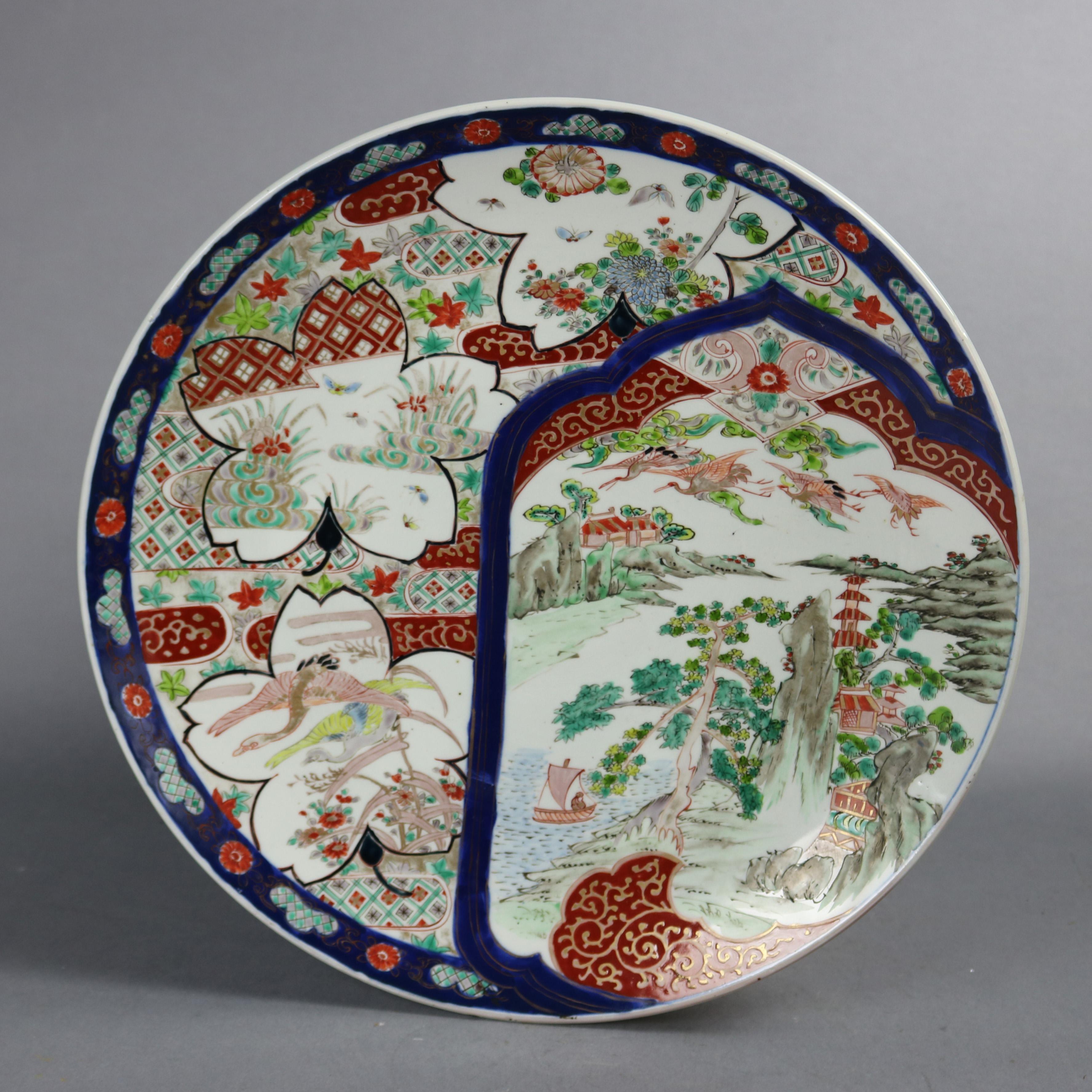 An antique Japanese Imari Porcelain charger offers floral form reserves having marsh scenes and pictorial countryside scene with pagoda, en veso with blue decoration, circa 1920

Measures: 1.75