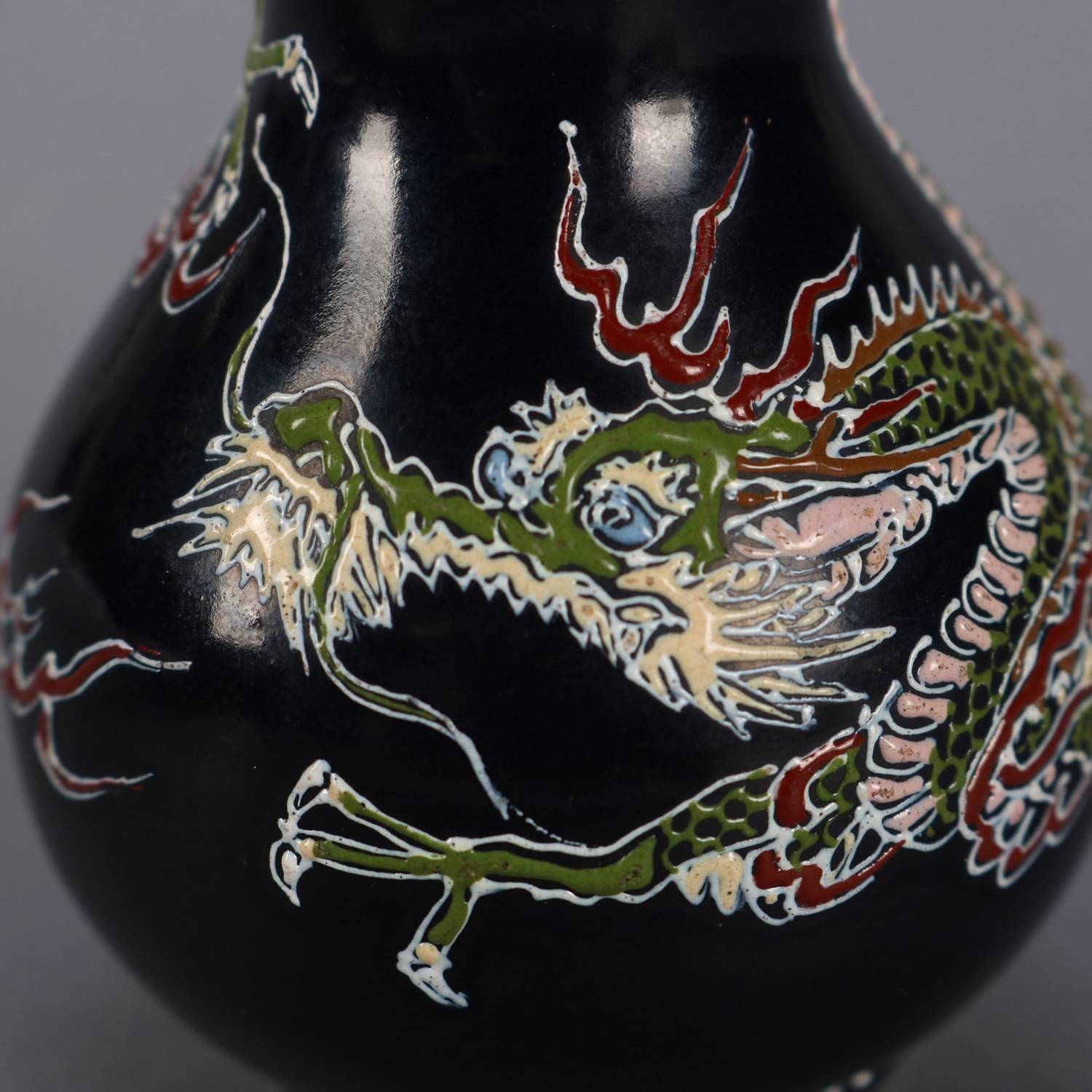 Antique Japanese Imari pottery cabinet vase features hand enameled wrap-around dragon and stylized tobacco leaf collar, signed on base, circa 1900

Measures: 4.5