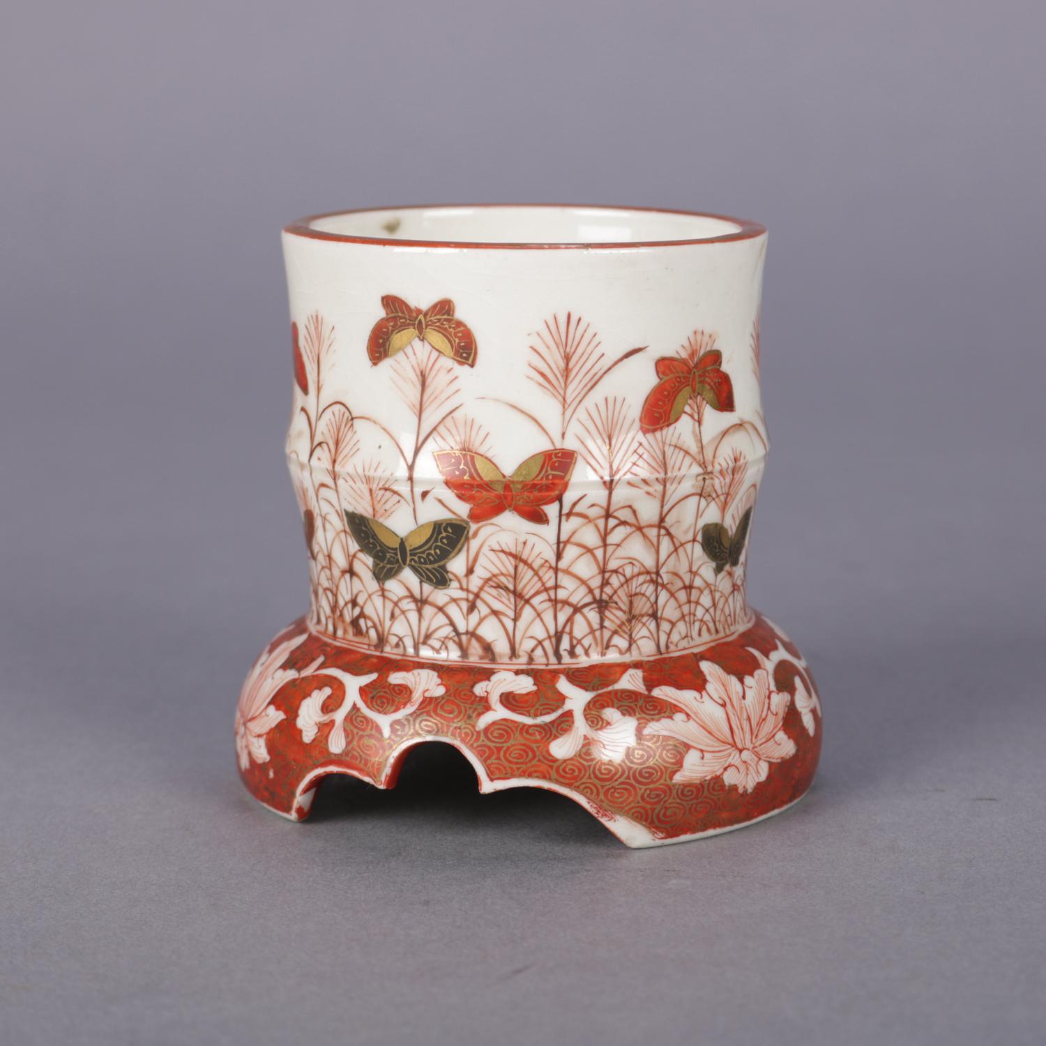 An antique Japanese Imari Porcelain brush wash features cylindrical form with hand painted butterfly garden scene and having gilt scroll highlights, chop mark signed on base, circa 1900

Measures: 3.25