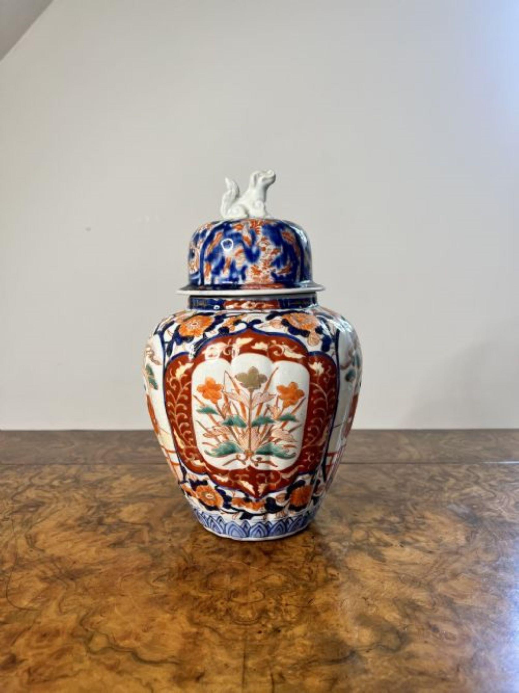 Antique Japanese imari lidded vase having a quality antique Japanese imari lidded vase with a dog of fo to the top of the lid, with a shaped body decorated with flowers, leaves, figures and scrolls hand painted in fantastic blue, white, green and