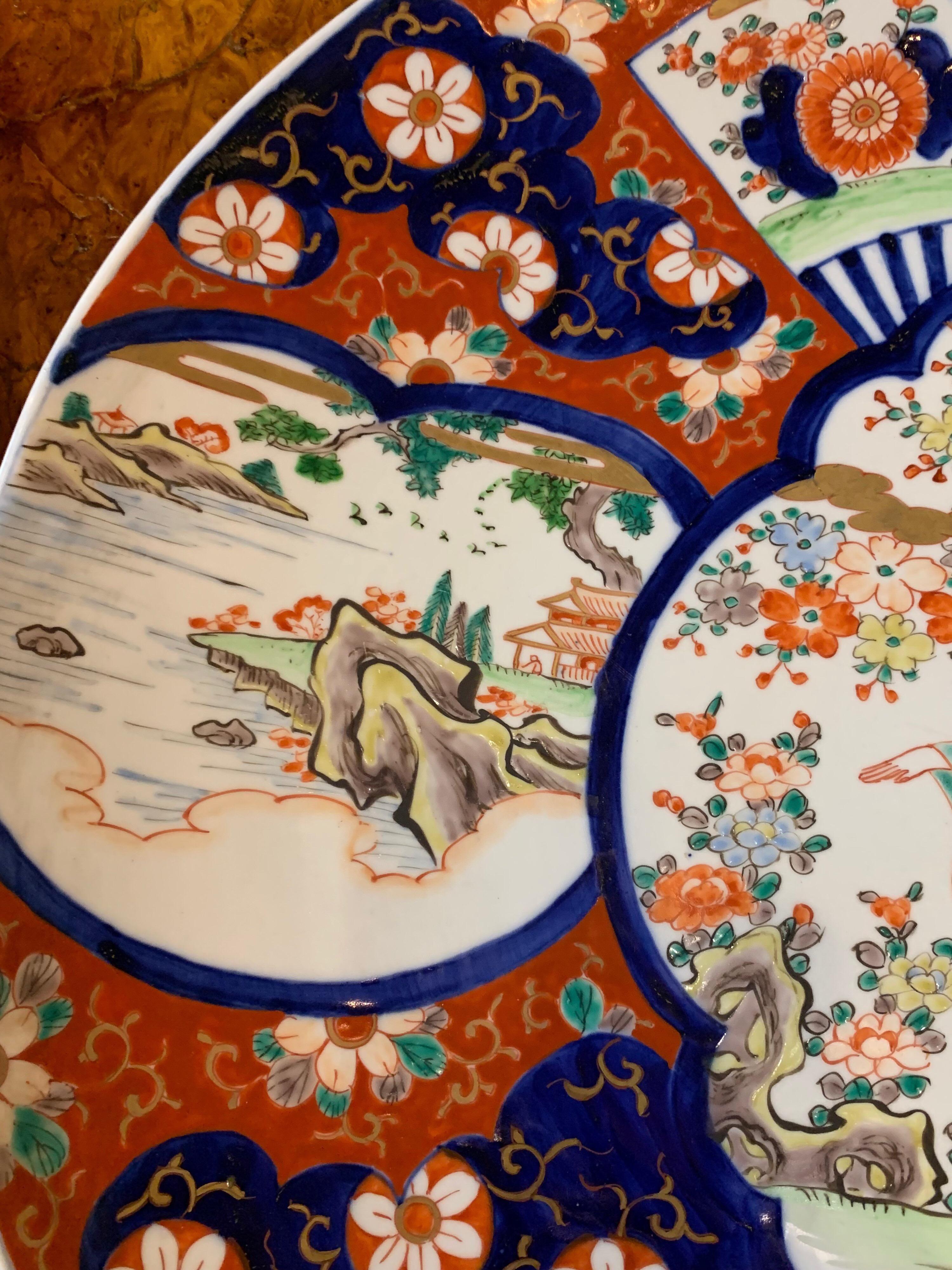 Beautiful Imari Porcelain charger with painted with vibrant colors of navy, orange, green and red.
Very fine quality!