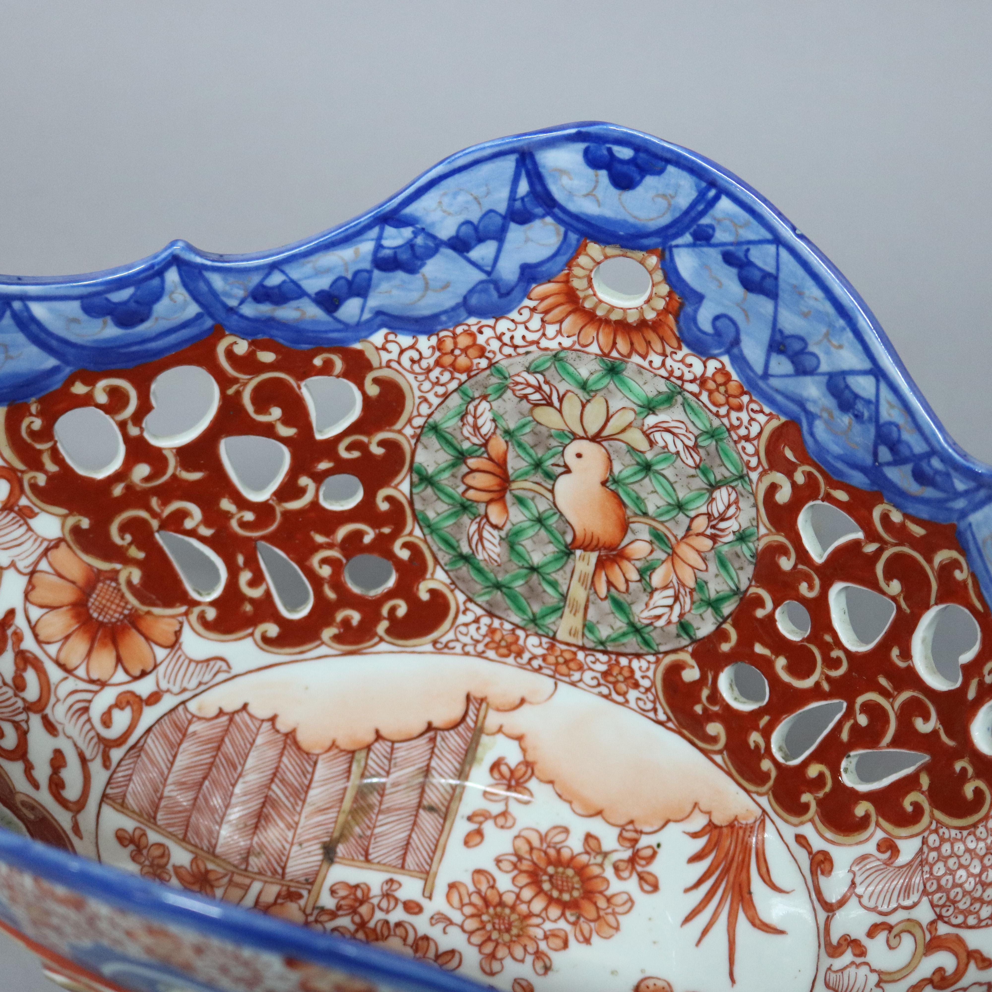 An antique Japanese Imari compote offers reserves with garden scenes on reticulated compote with shaped rim raised on single column pedestal, circa 1900.

Measures - 11.5