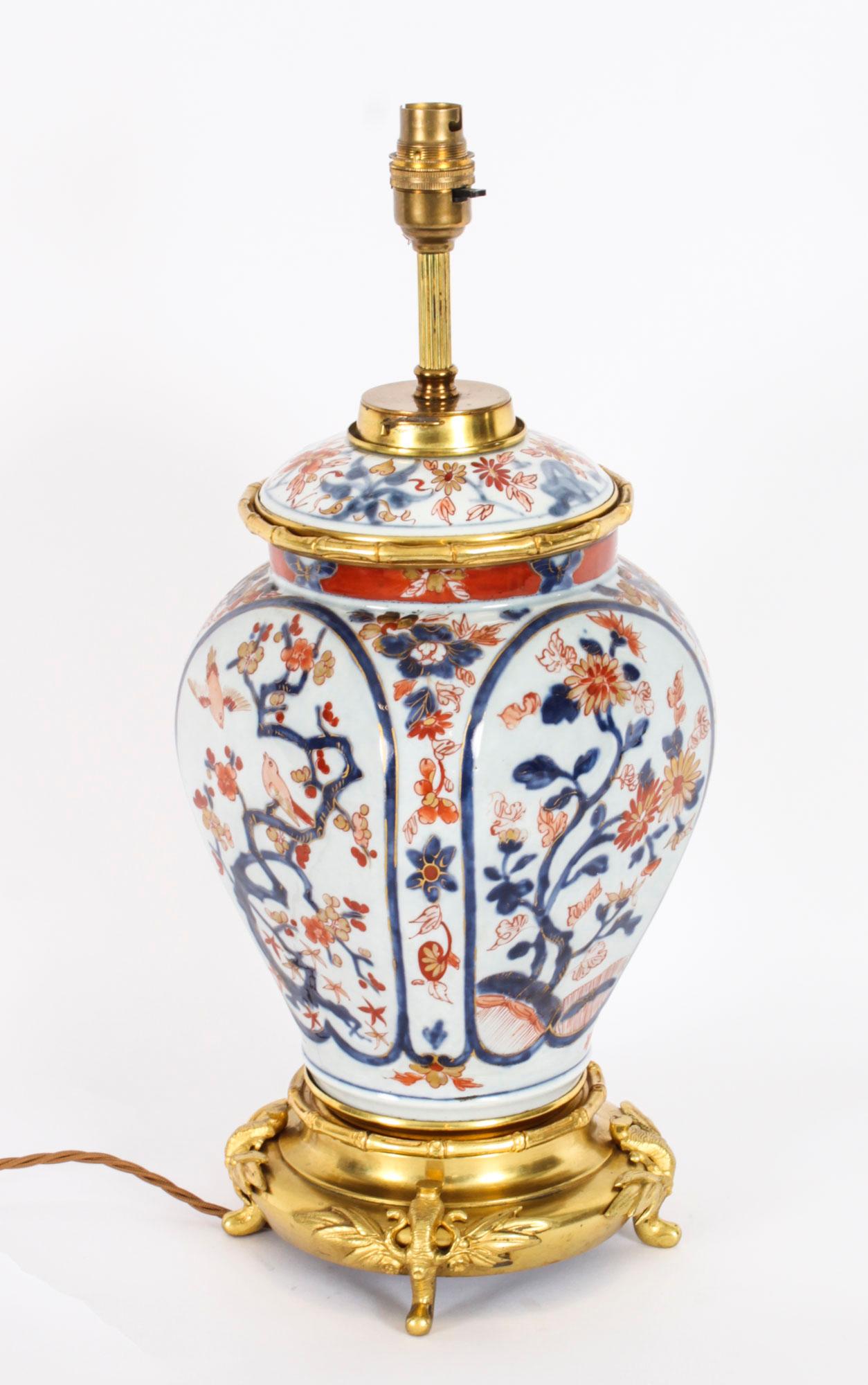 This is a superb decorative Japanese Imari table lamp on stand, circa 1840 in date.
 
The lamp has a bulbous shape and features Japanese decoration in the traditional Imari colour scheme of blue orange and red, profusely decorated with birds and